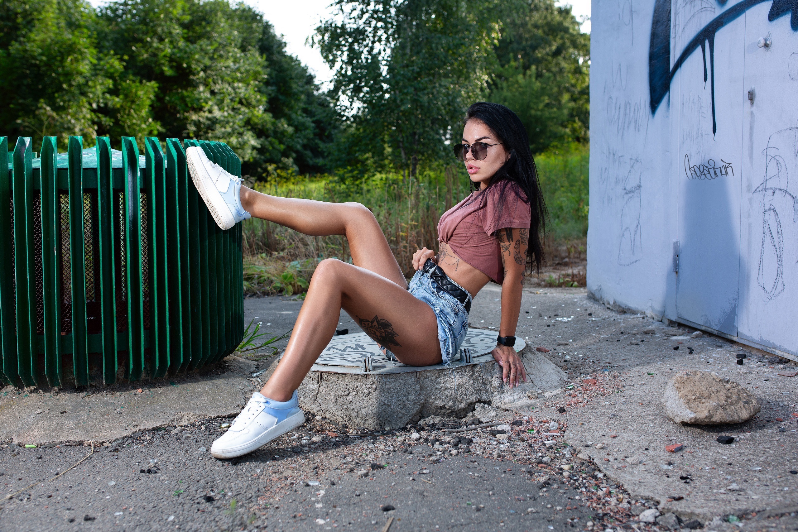 Woman in shorts and athletic shoes posing outdoors HD Wallpaper