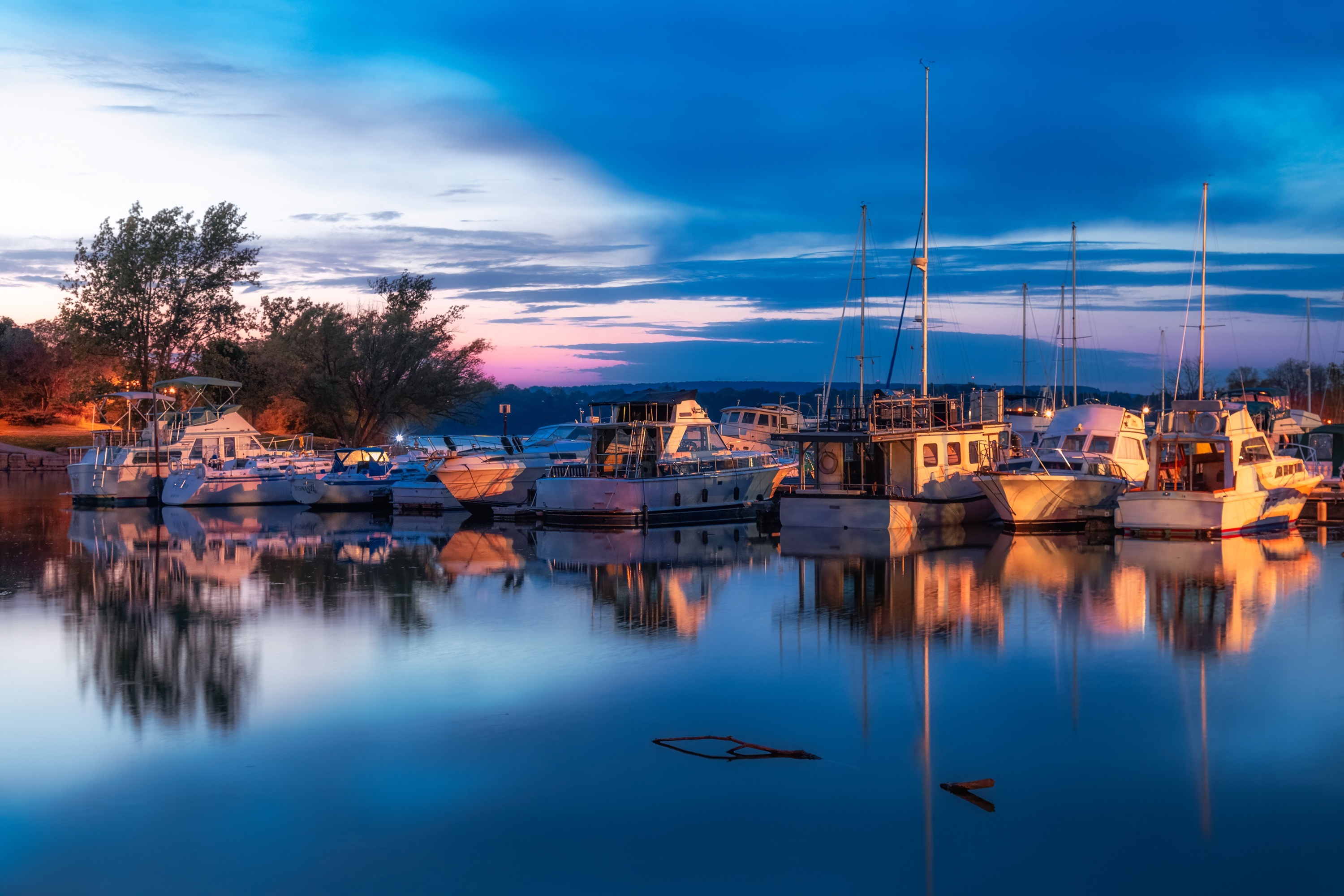 Boats docked in a harbor at sunset HD Wallpaper