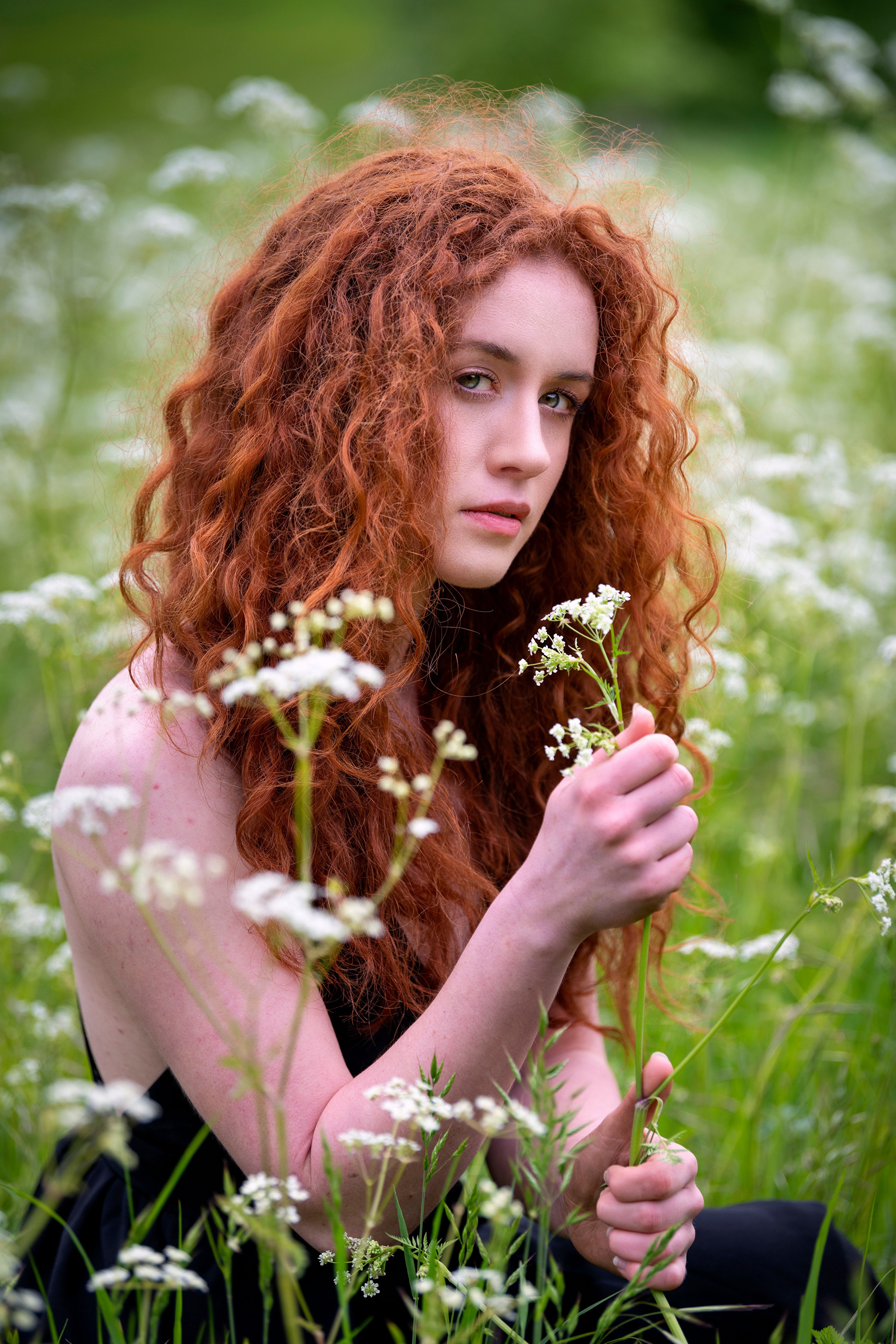 Redhead girl in a field of flowers HD Phone Wallpaper