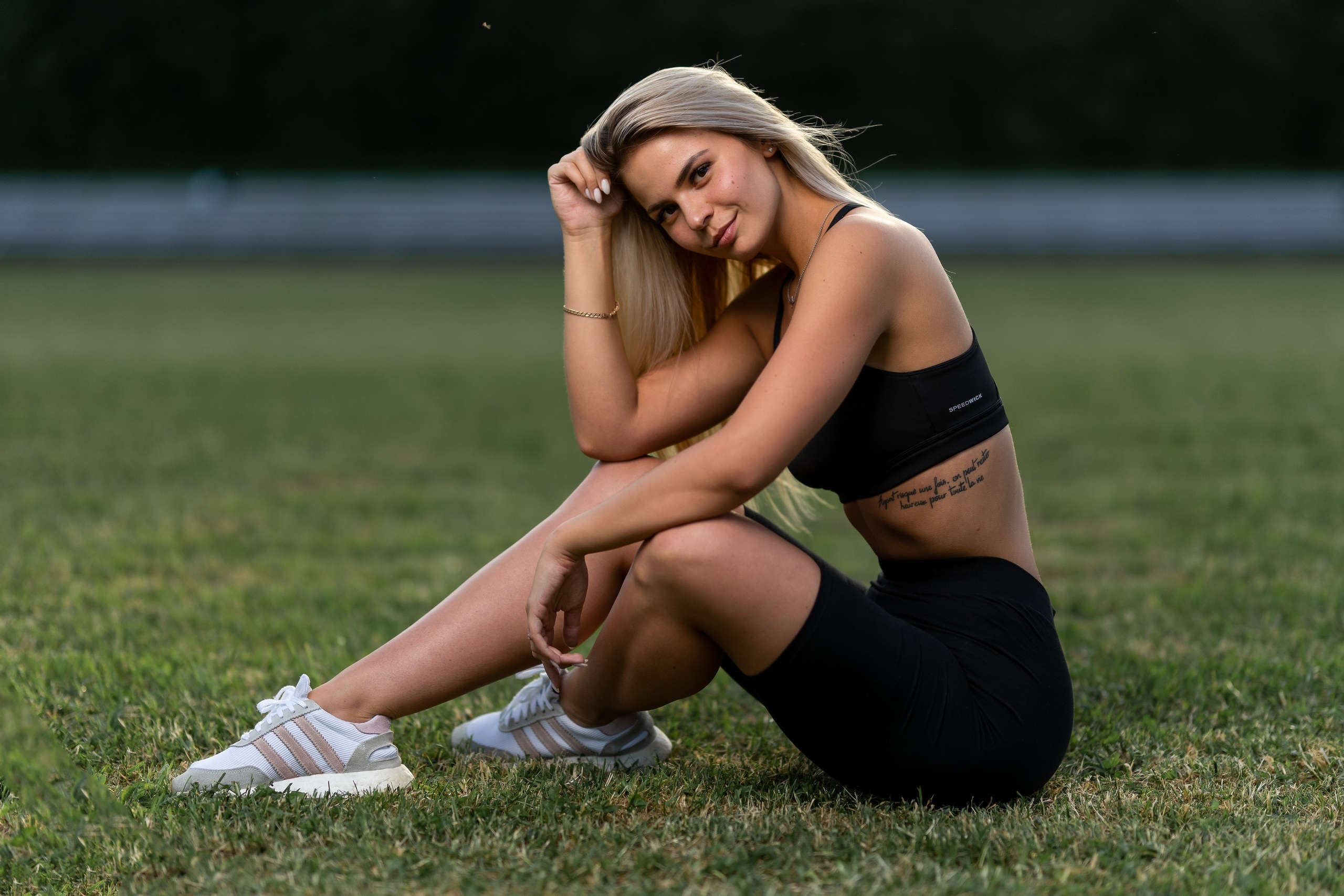 Nastya Mikheeva sitting on grass wearing athletic wear HD Wallpaper