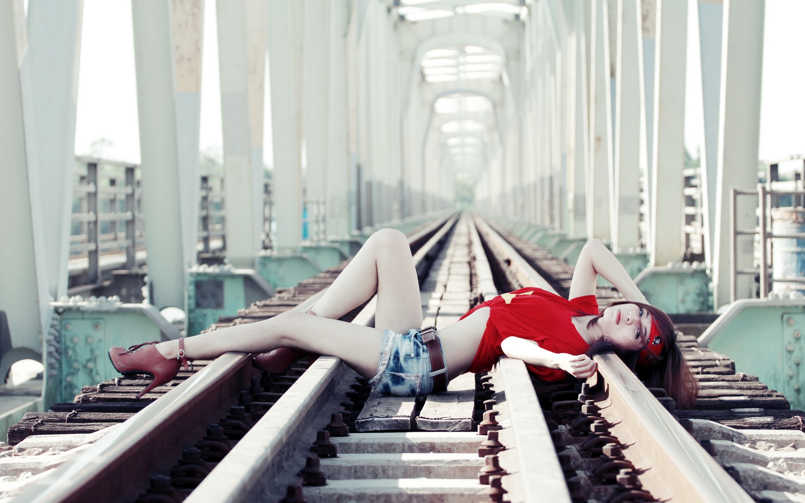Woman lying on train tracks HD Wallpaper
