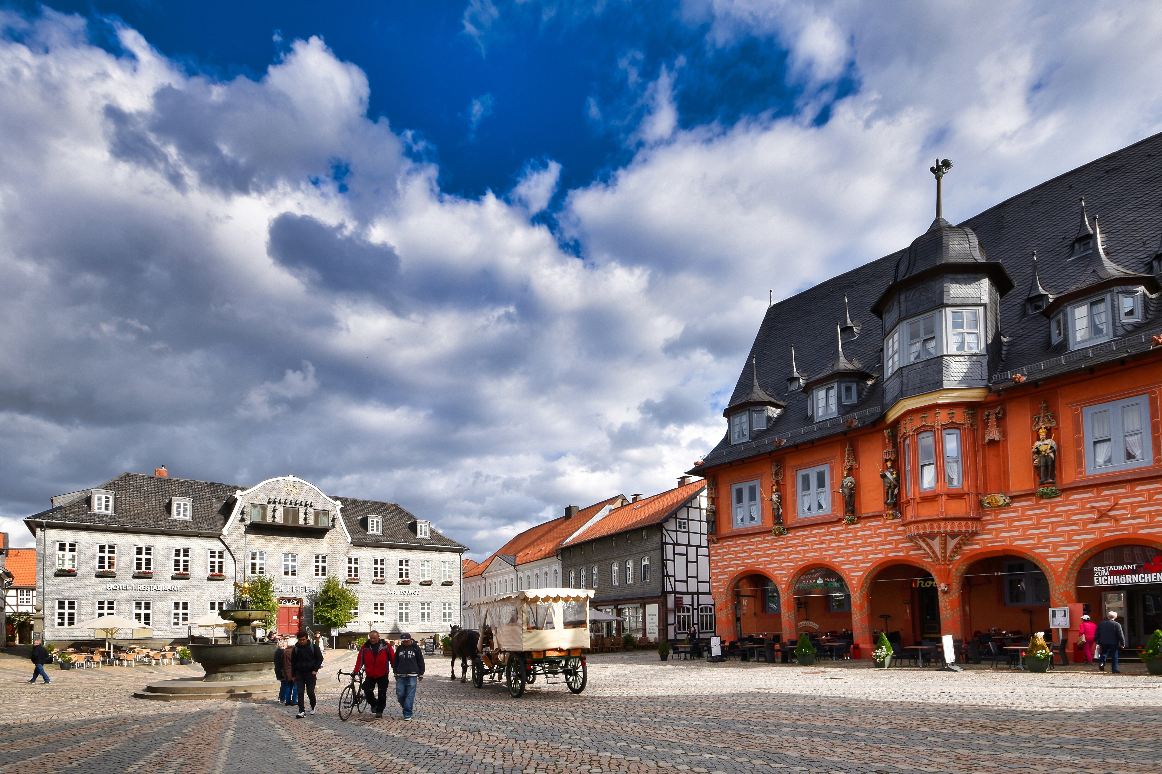 Town square in Goslar, Germany with historic buildings and carriage HD Wallpaper