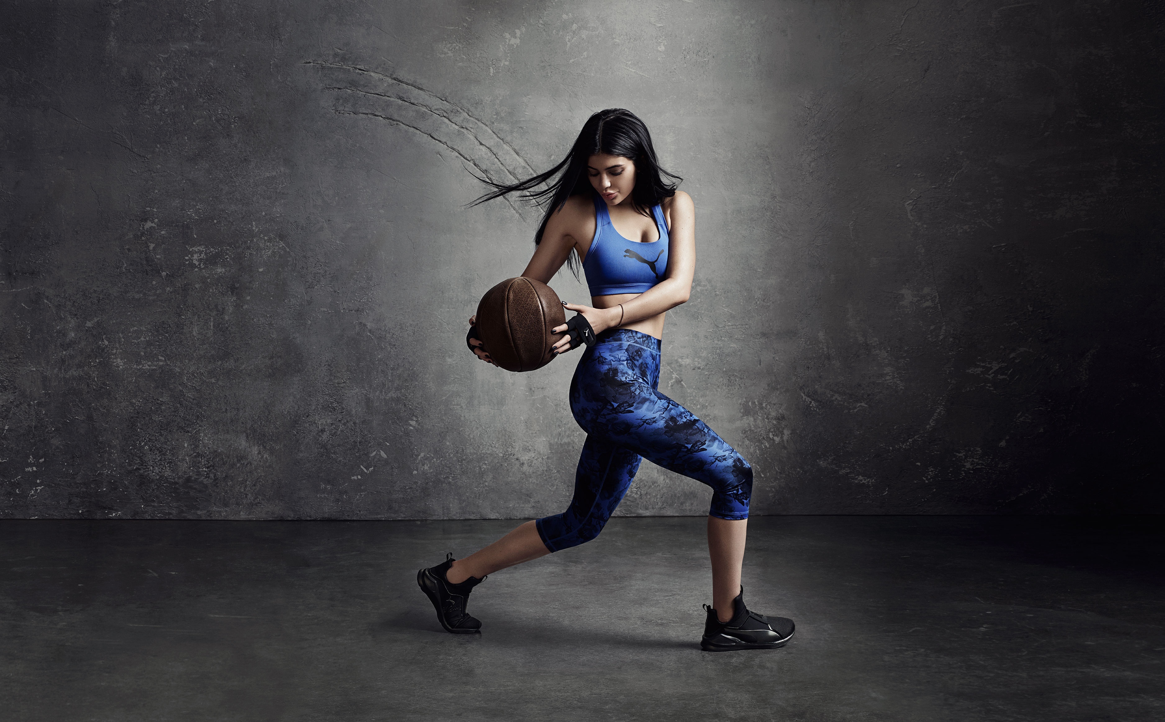 Kylie Jenner holding a medicine ball in Puma athletic wear HD Wallpaper