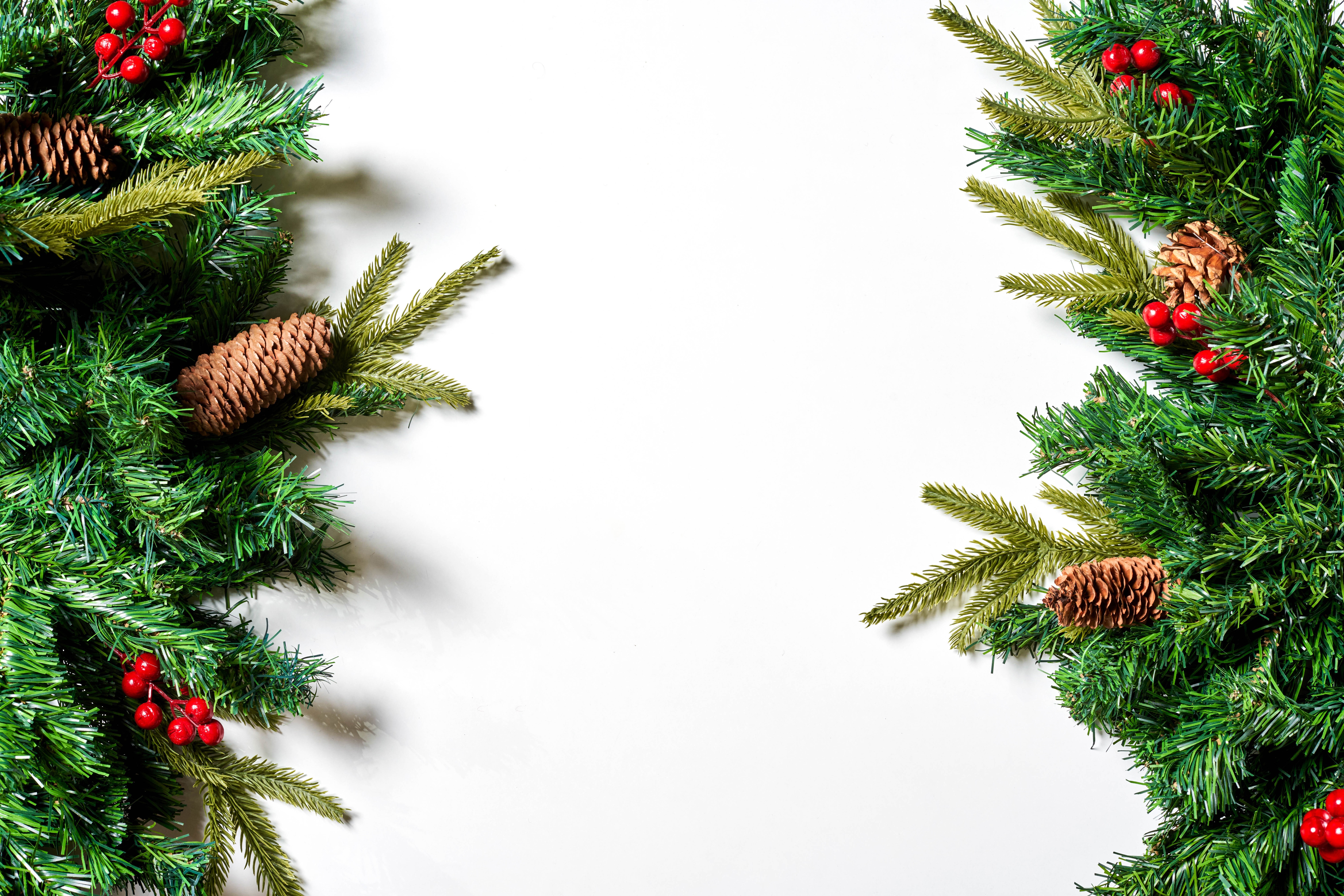 Christmas garland with pine cones and berries on white background HD Wallpaper
