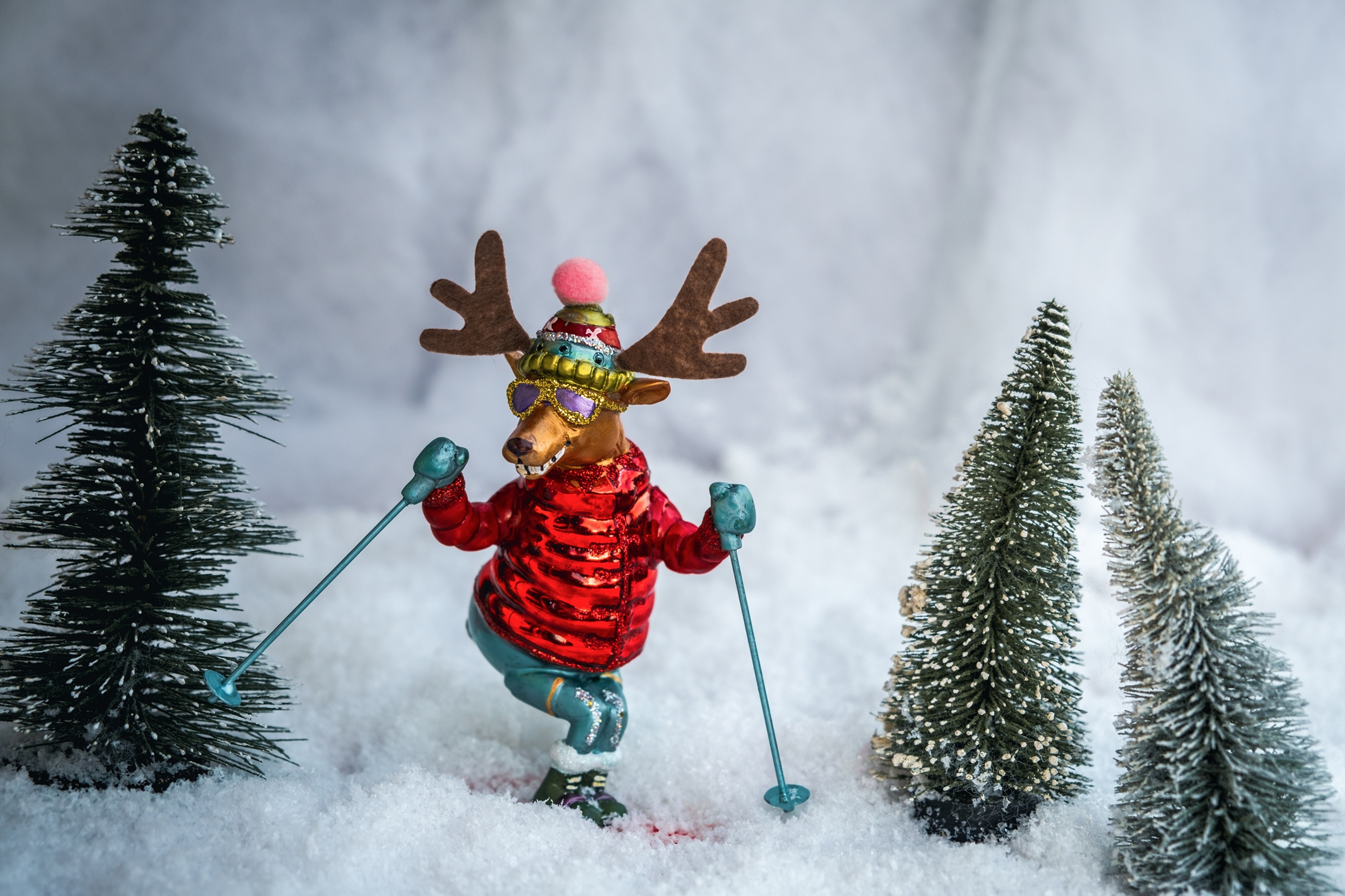 4K Skiing Deer Toy with Christmas Trees in Snow HD Wallpaper