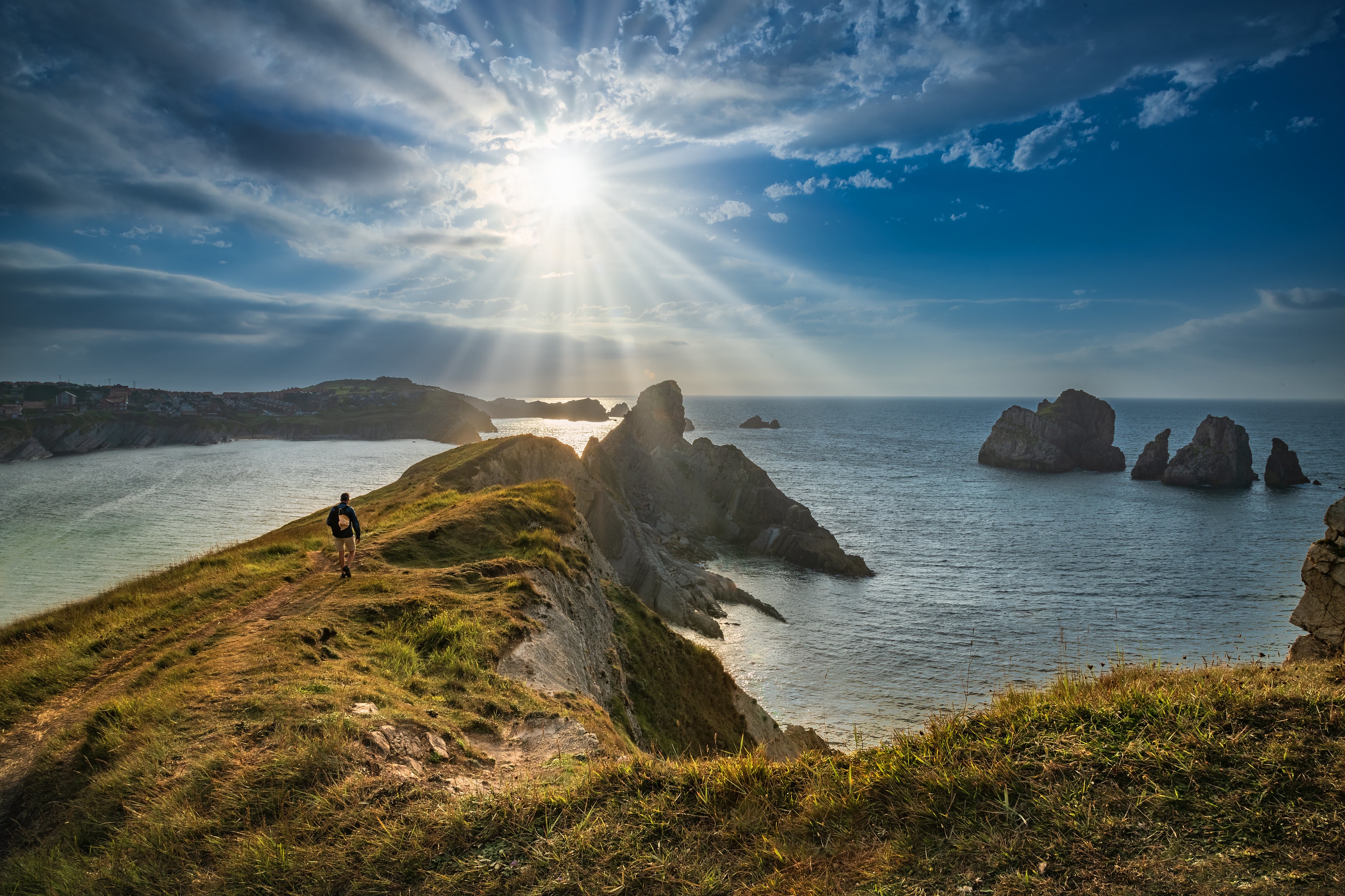 Hiker on Cantabrian Coast with Sun Rays HD Wallpaper