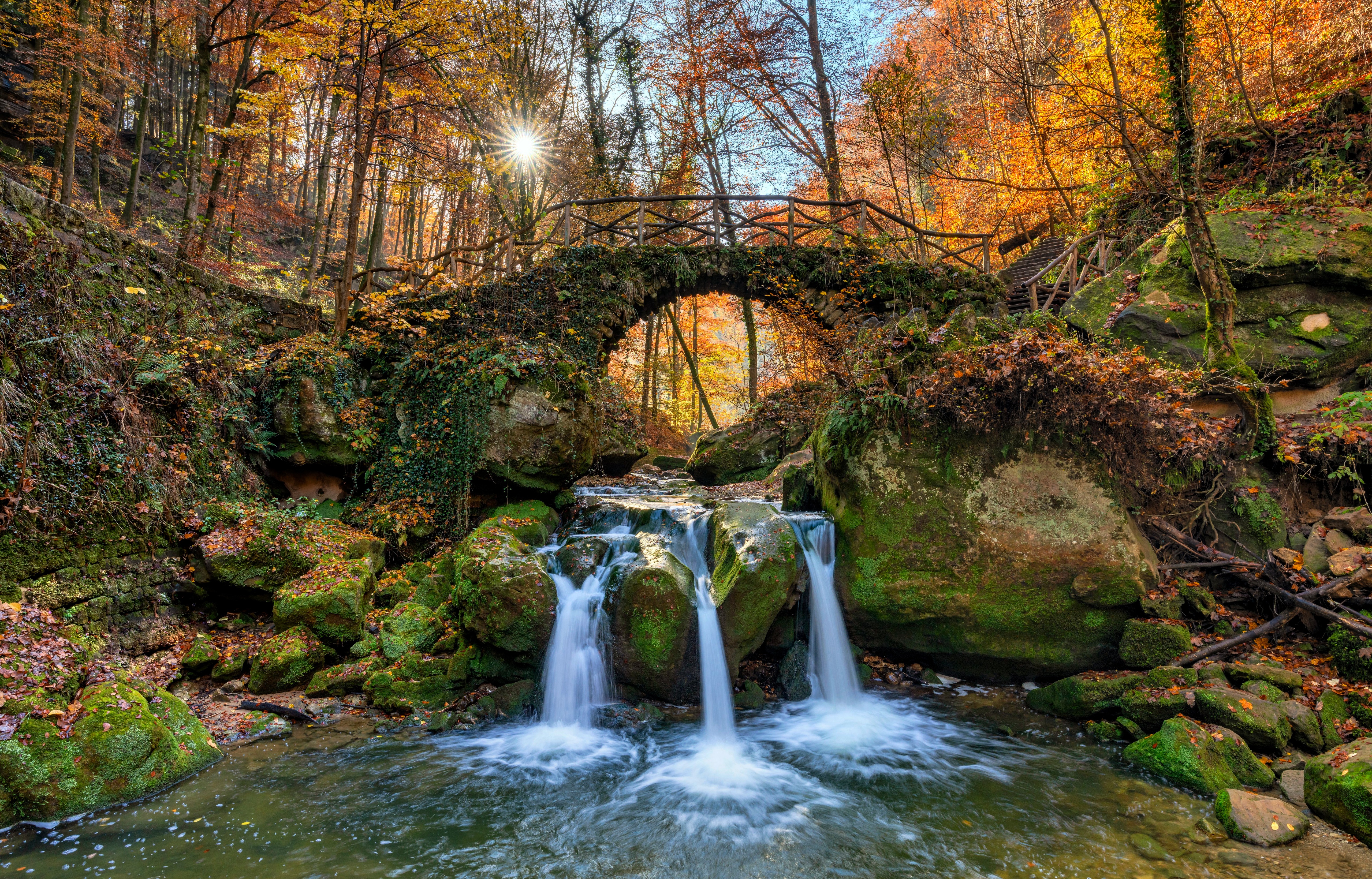 Stone bridge over a waterfall in autumn forest, Mullerthal, Luxembourg HD Wallpaper
