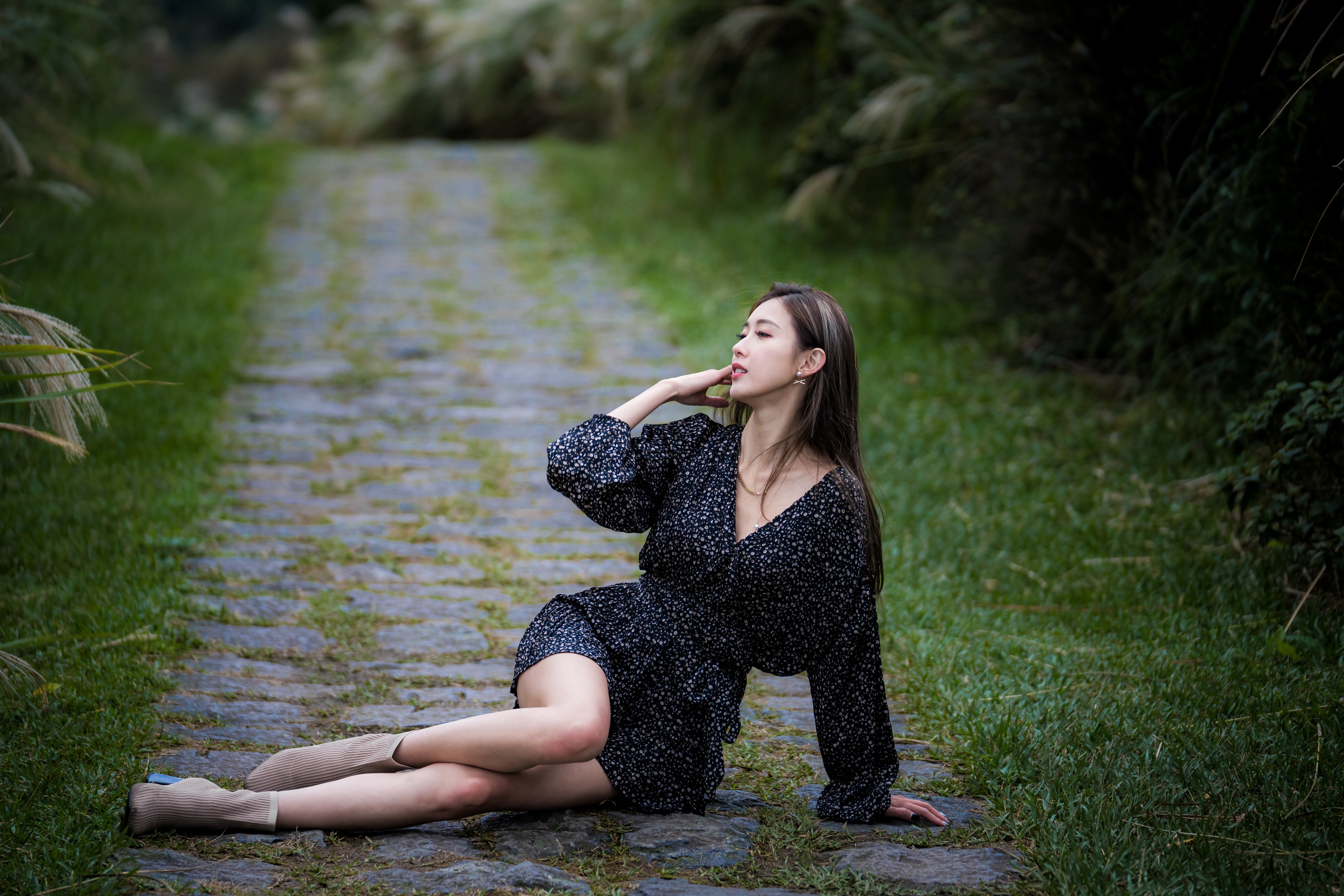 Asian woman in dress posing on stone path HD Wallpaper