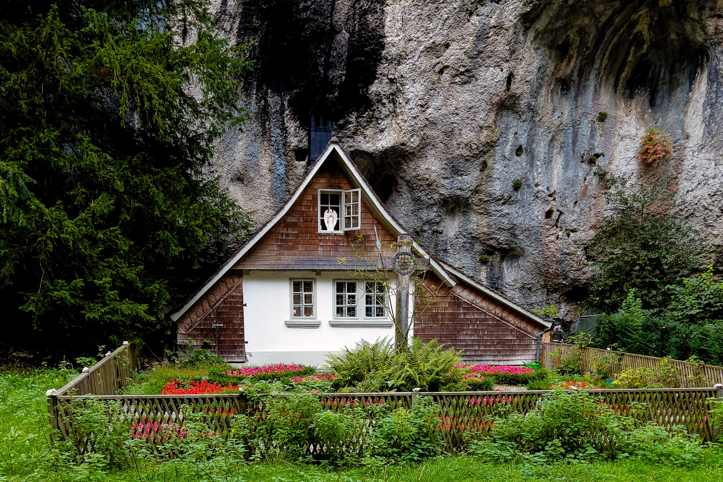 House built into a crag in Switzerland with a garden HD Wallpaper