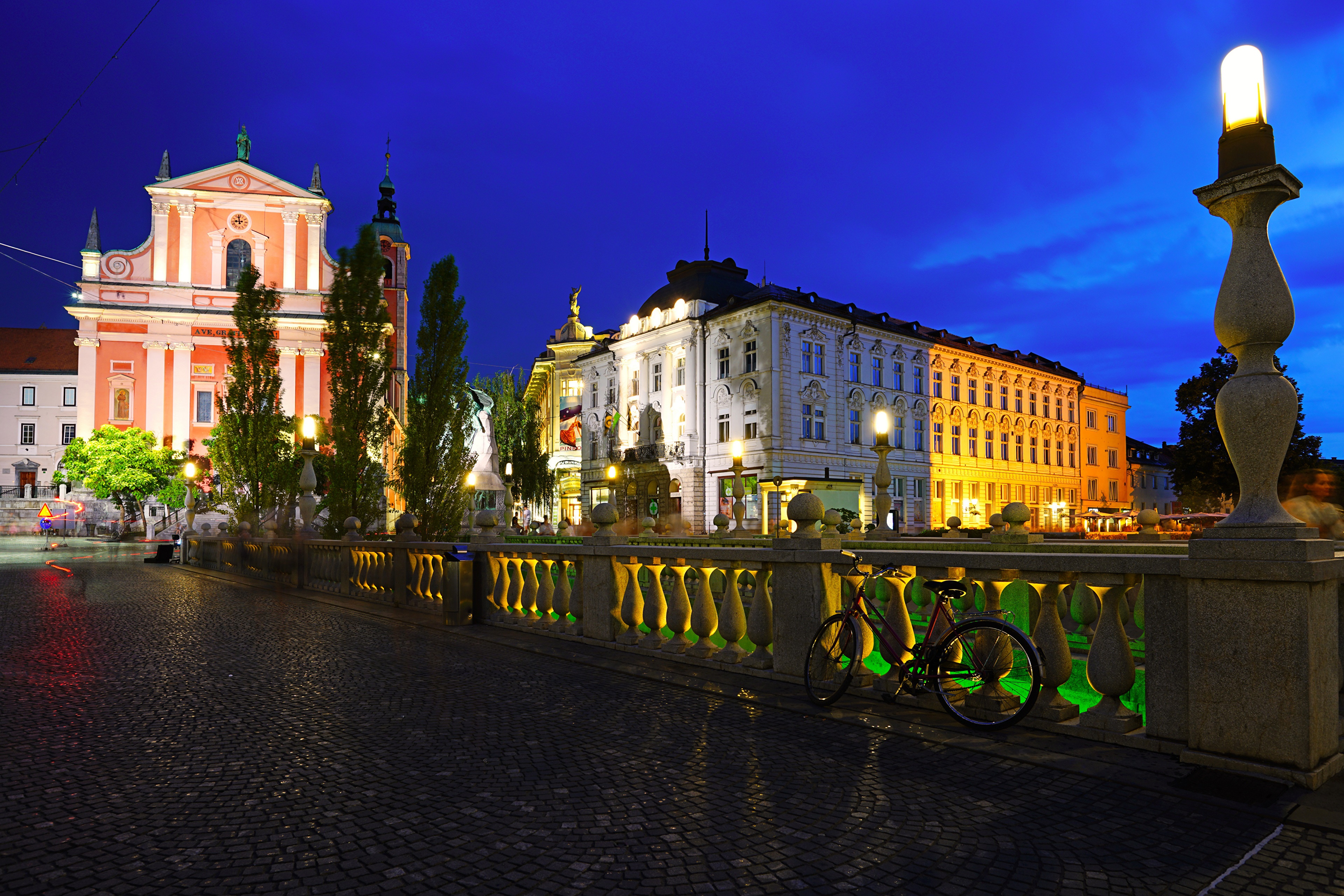 4K night view of Ljubljana, Slovenia with illuminated buildings and bridge HD Wallpaper