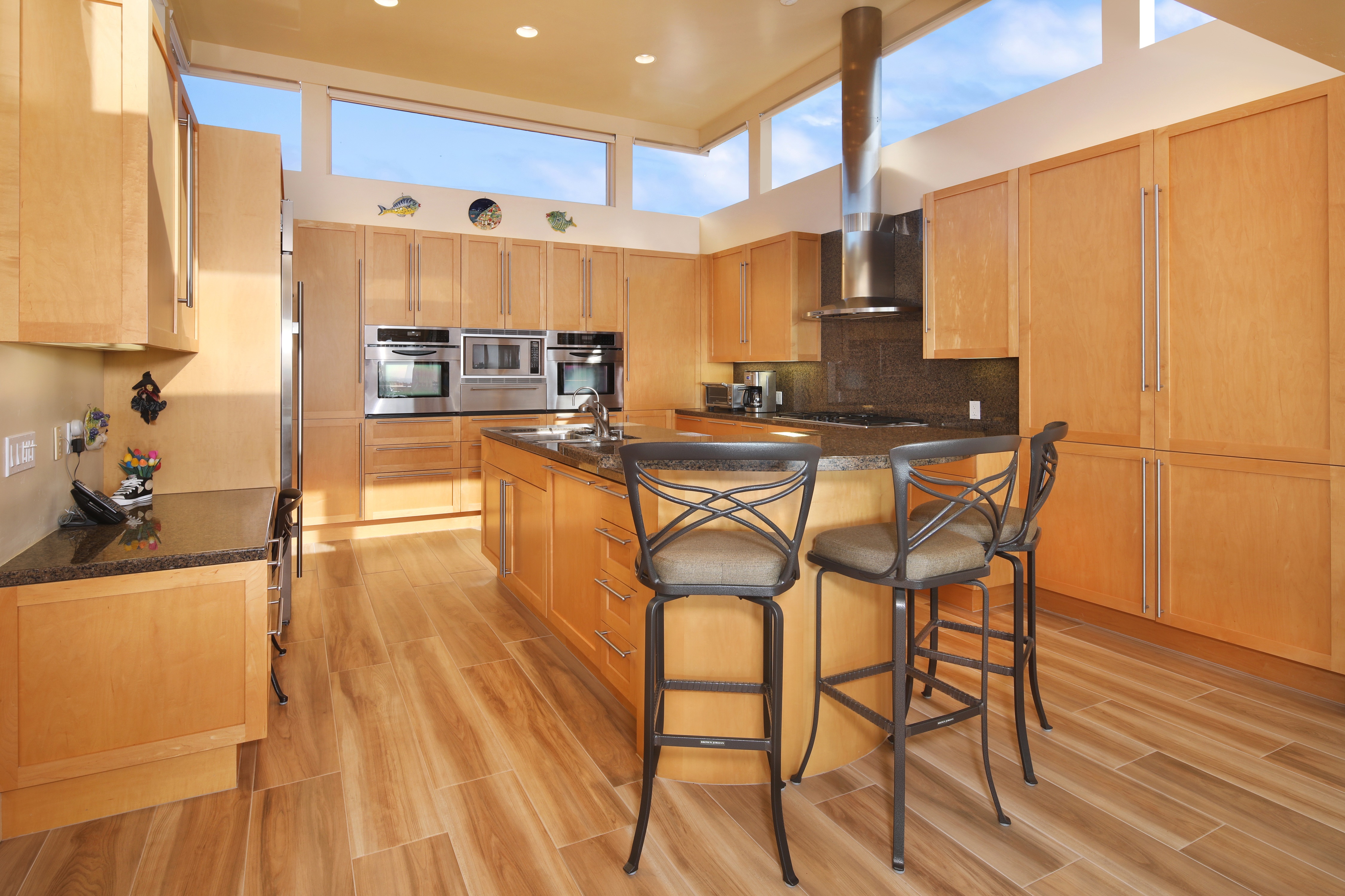 Modern kitchen with island and bar stools HD Wallpaper