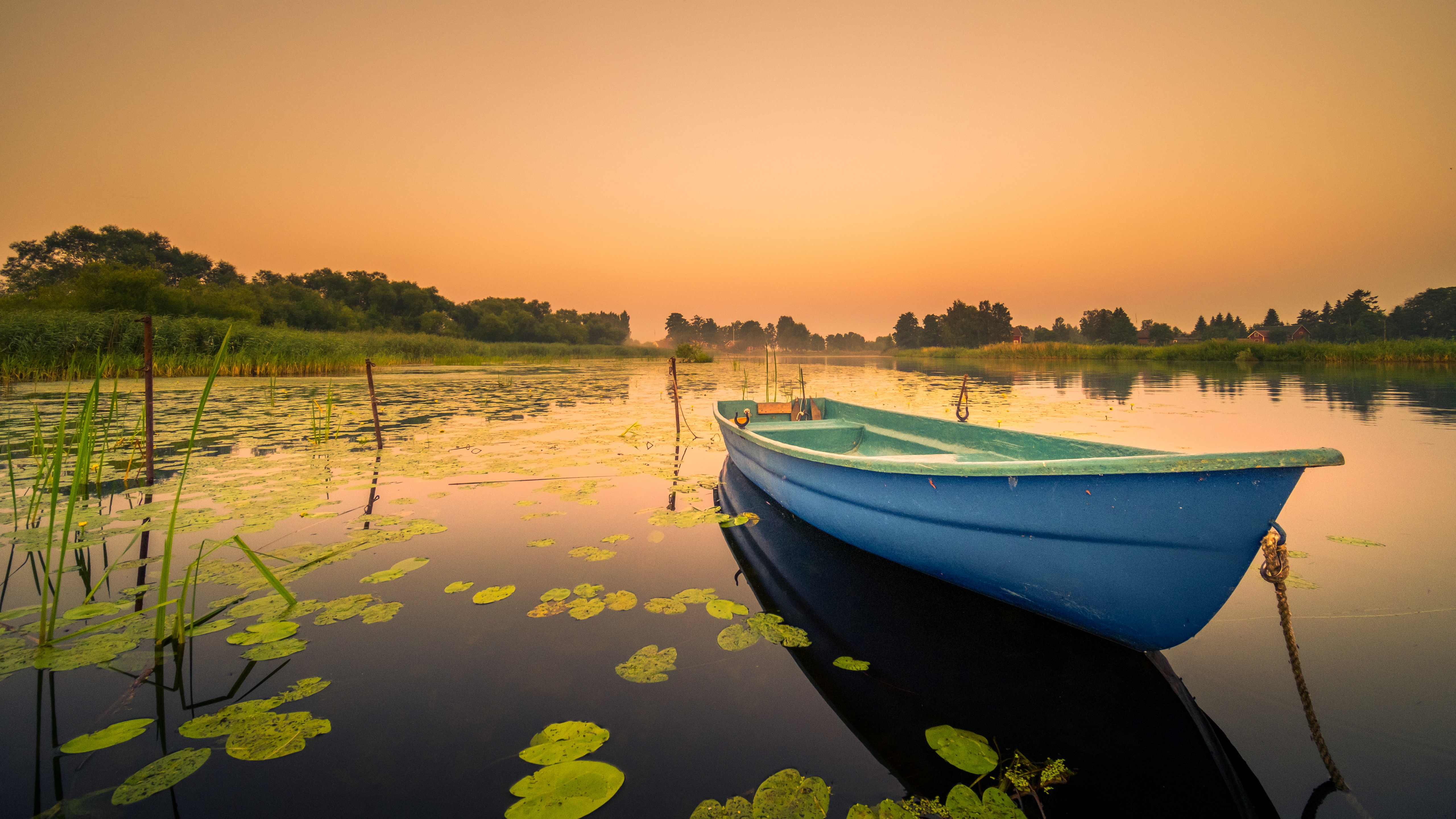 Blue boat on a lake at sunrise HD Wallpaper