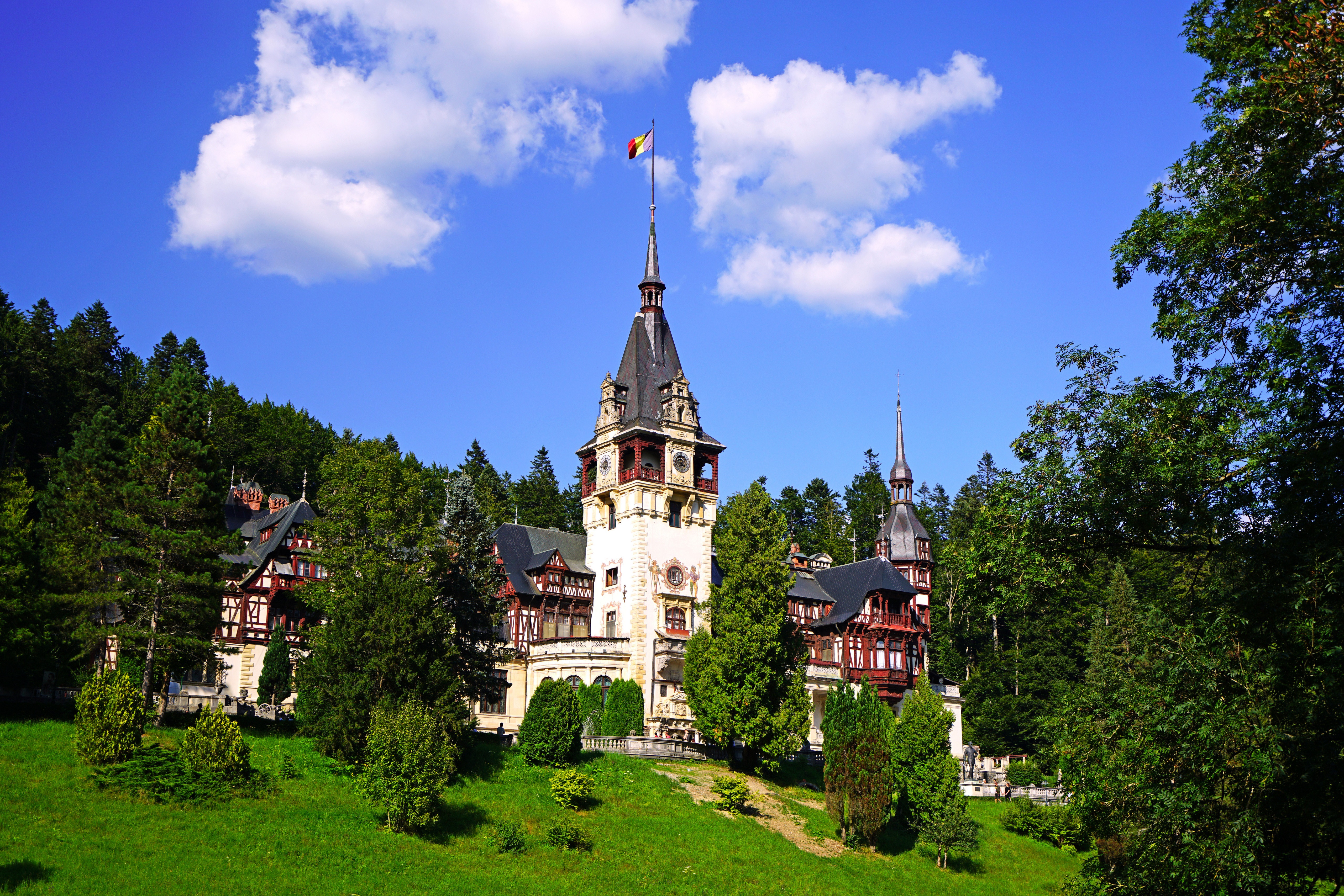 Peles Castle in Romania with Trees and Clouds HD Wallpaper