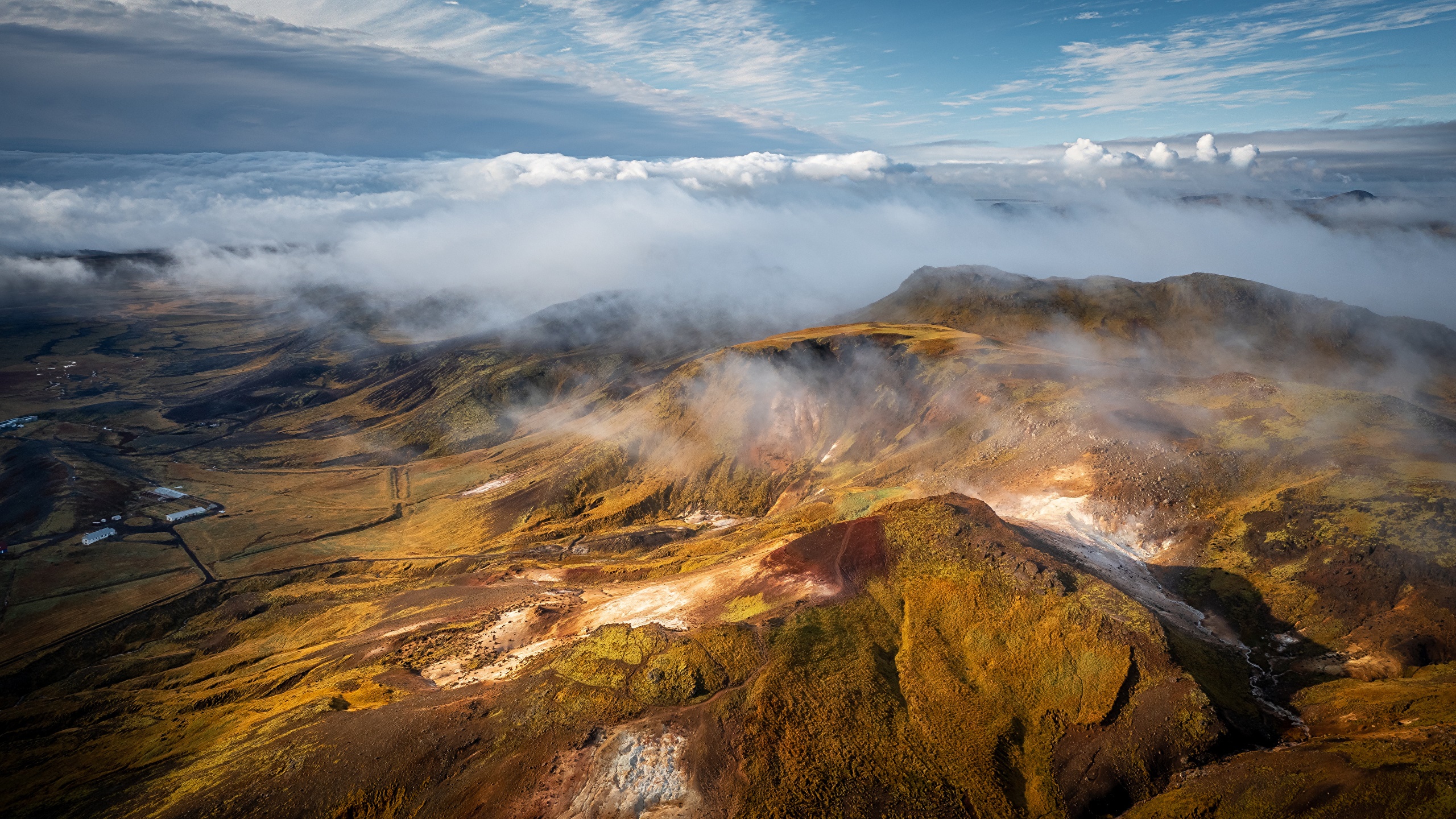 Aerial view of Icelandic mountains with clouds and mist HD Wallpaper