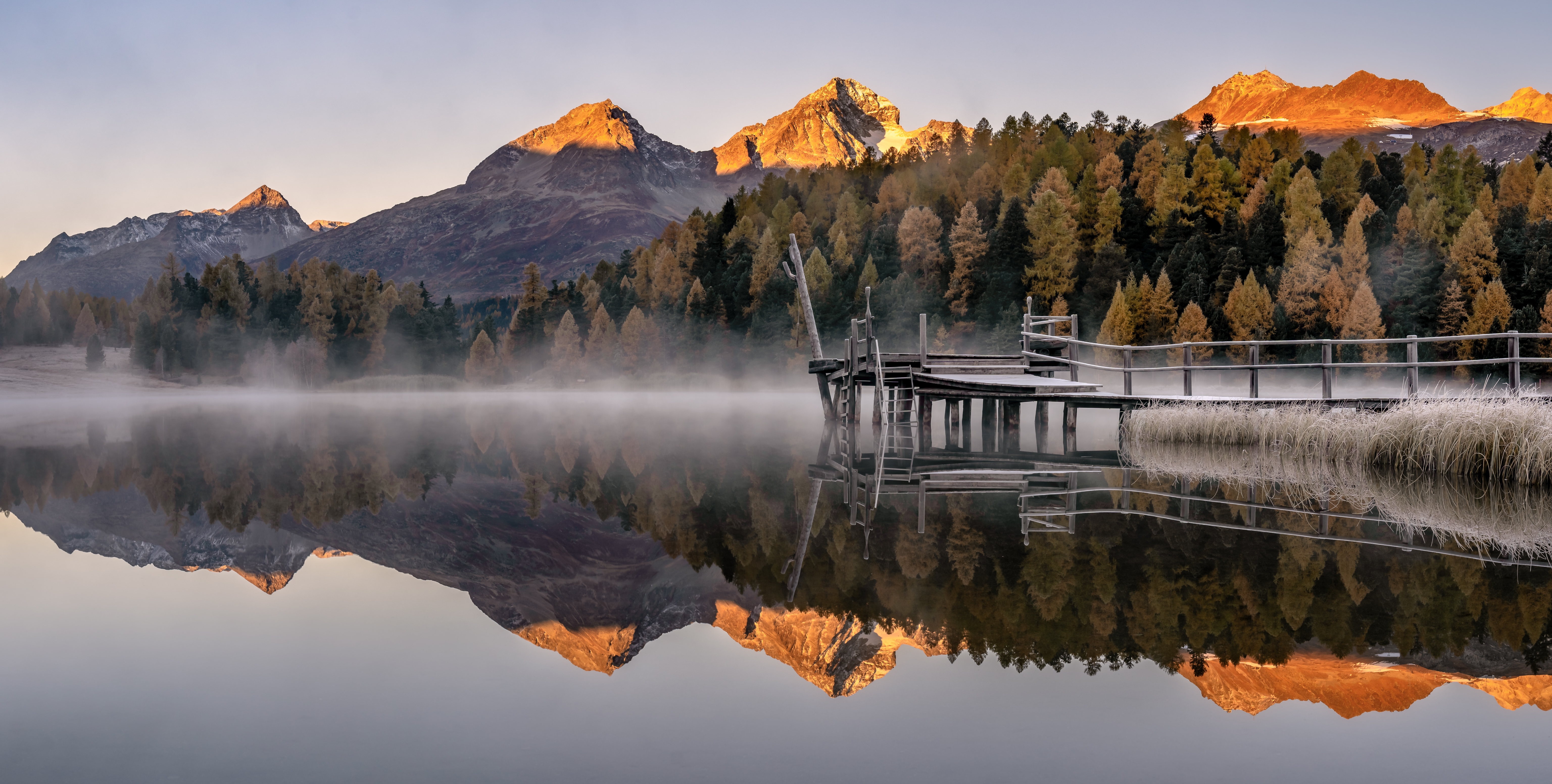 Autumn morning fog over a mountain lake in Switzerland HD Wallpaper