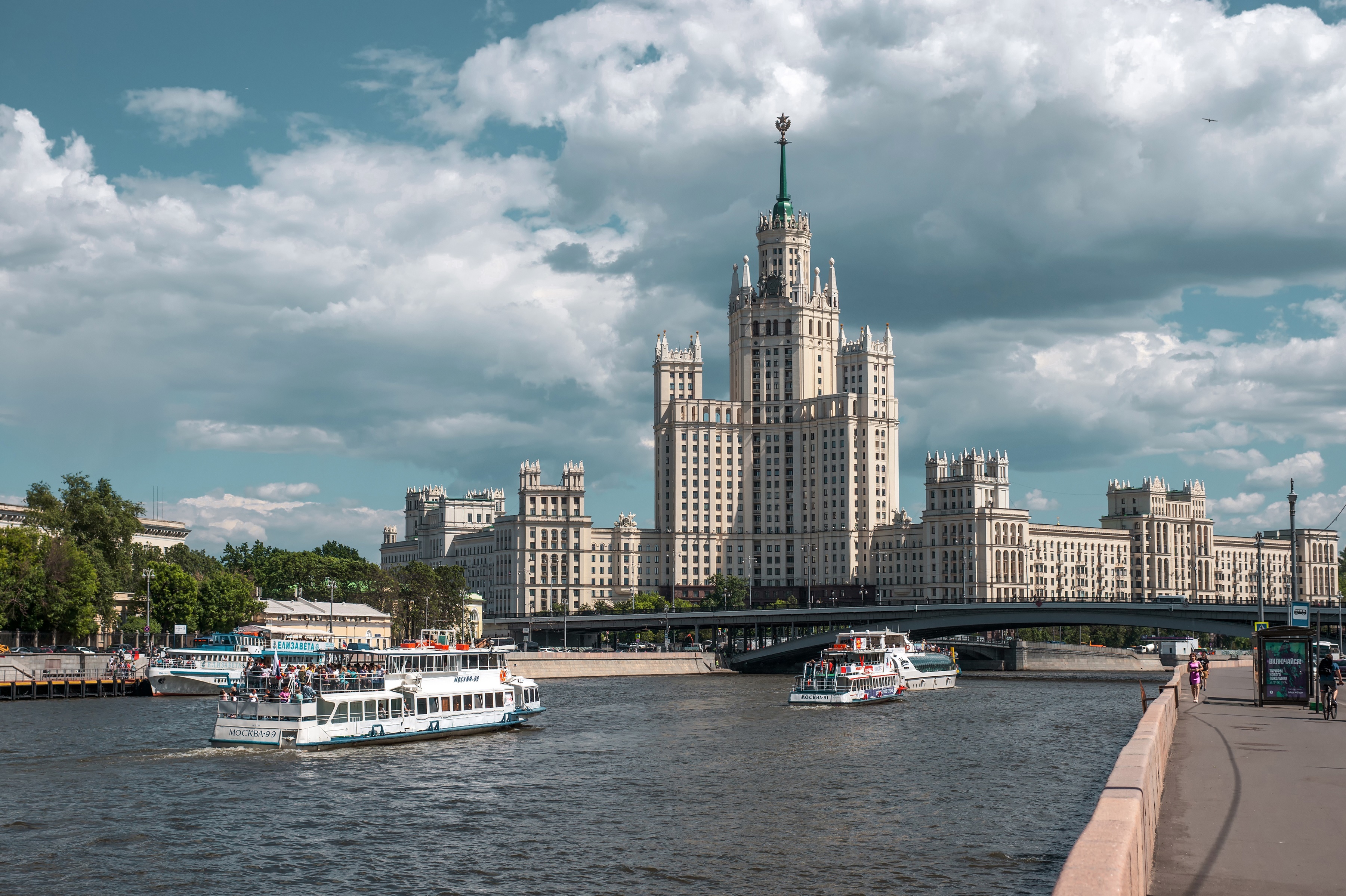 Stalinist skyscraper on Moscow River with boats HD Wallpaper