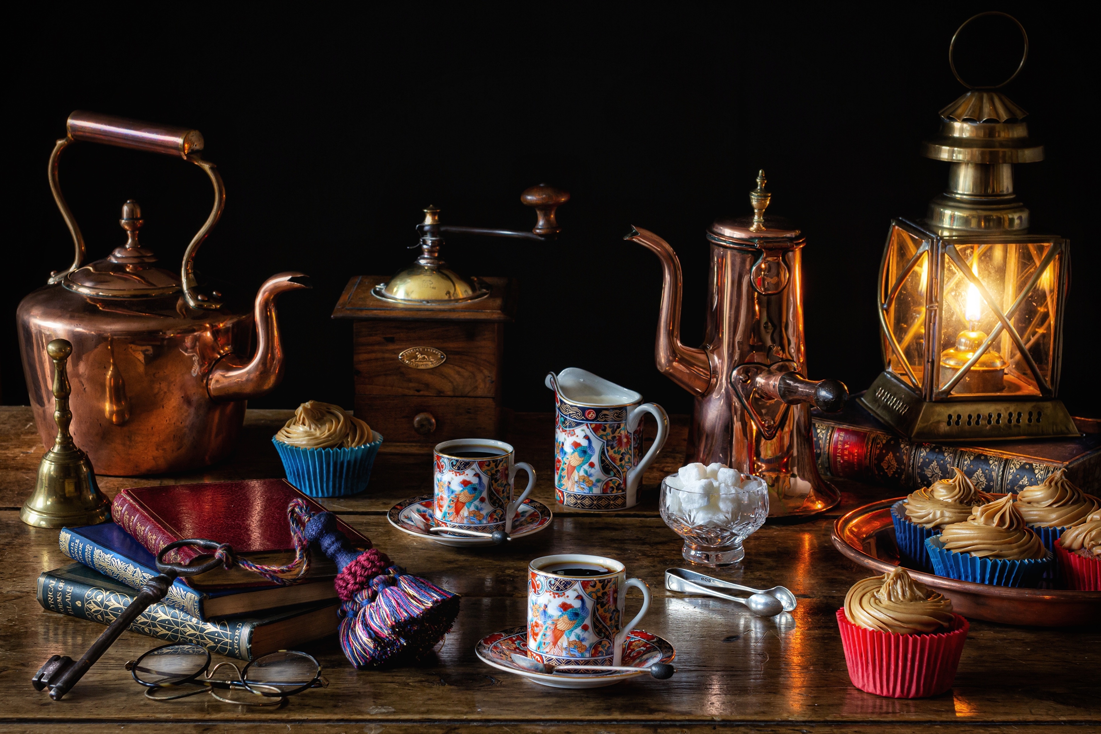 Still-life with copper kettle, coffee mill, cupcakes, and lamp HD Wallpaper