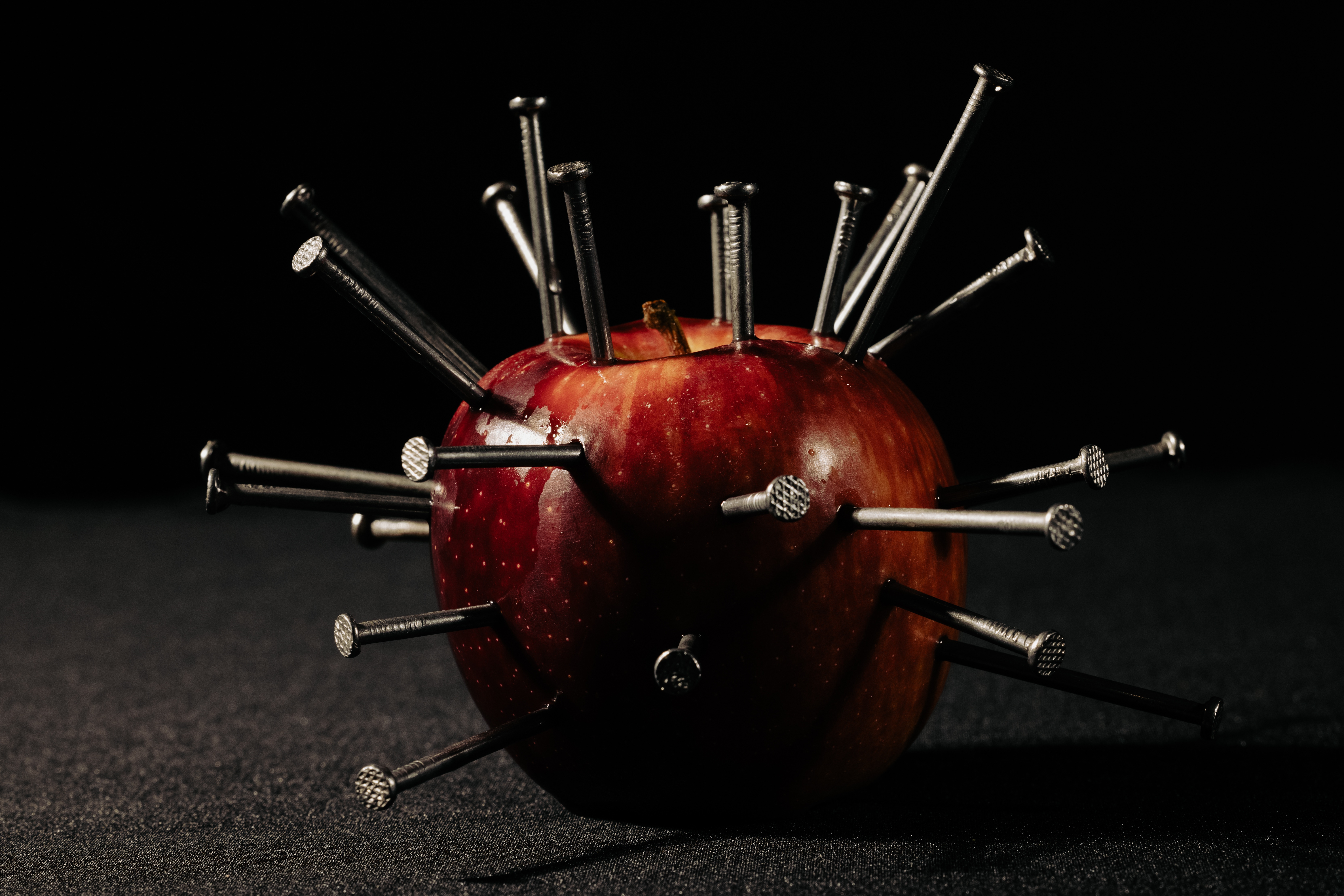 Red apple with nails HD Wallpaper