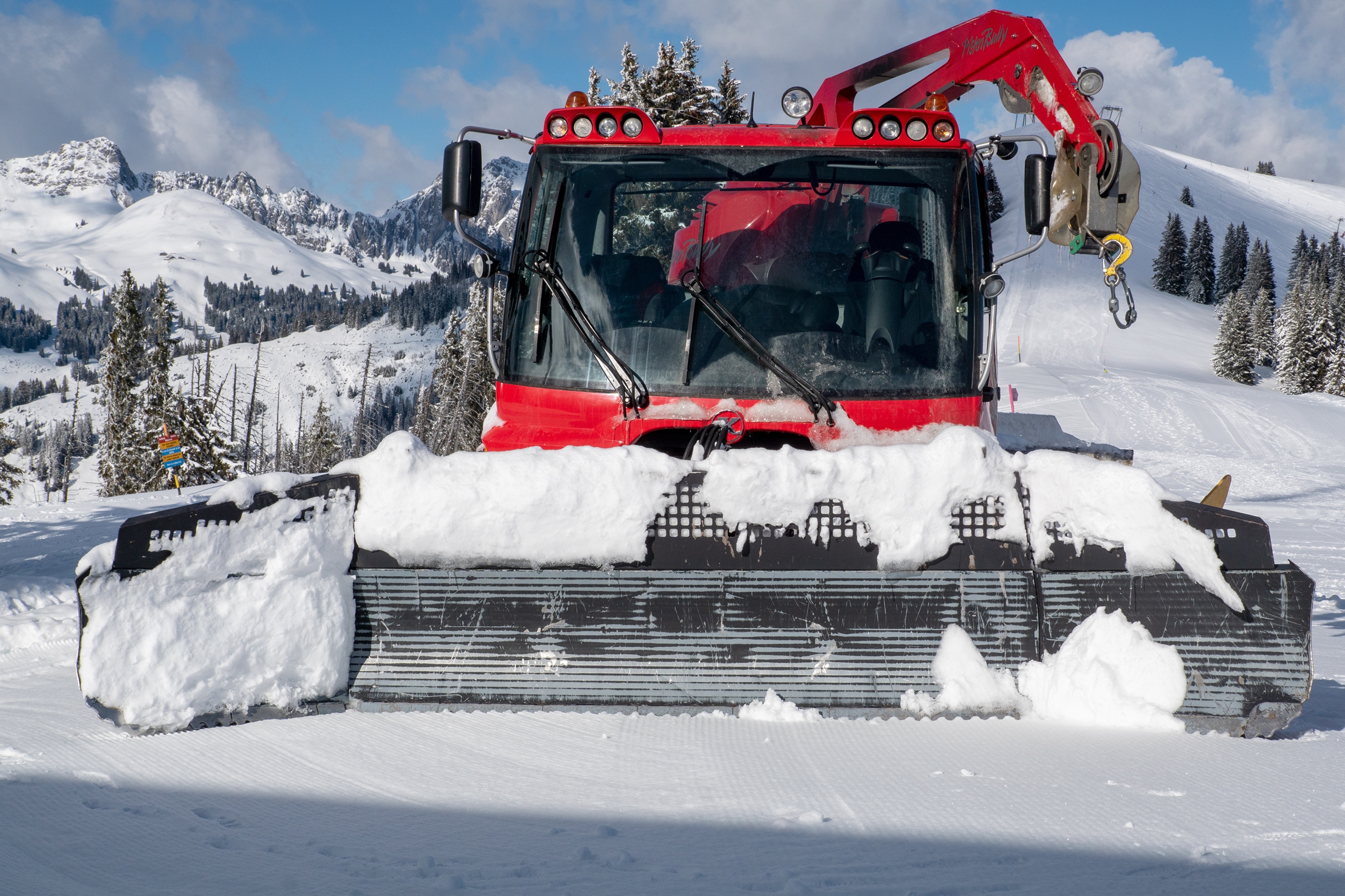 Red Snowcat Pisten Bully 400 on Snowy Mountain HD Wallpaper
