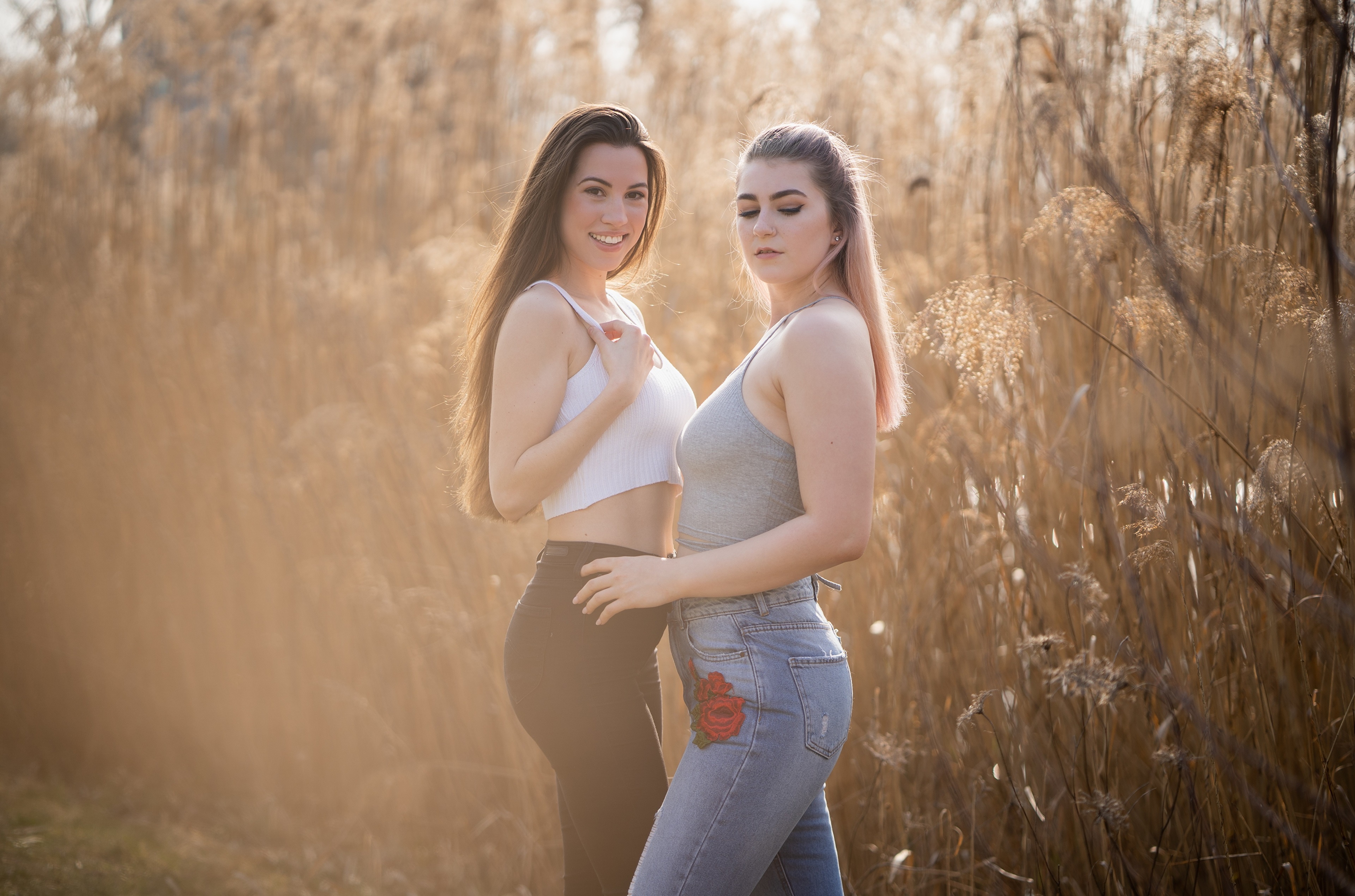 Julia and Madeleine in a field of reeds HD Wallpaper