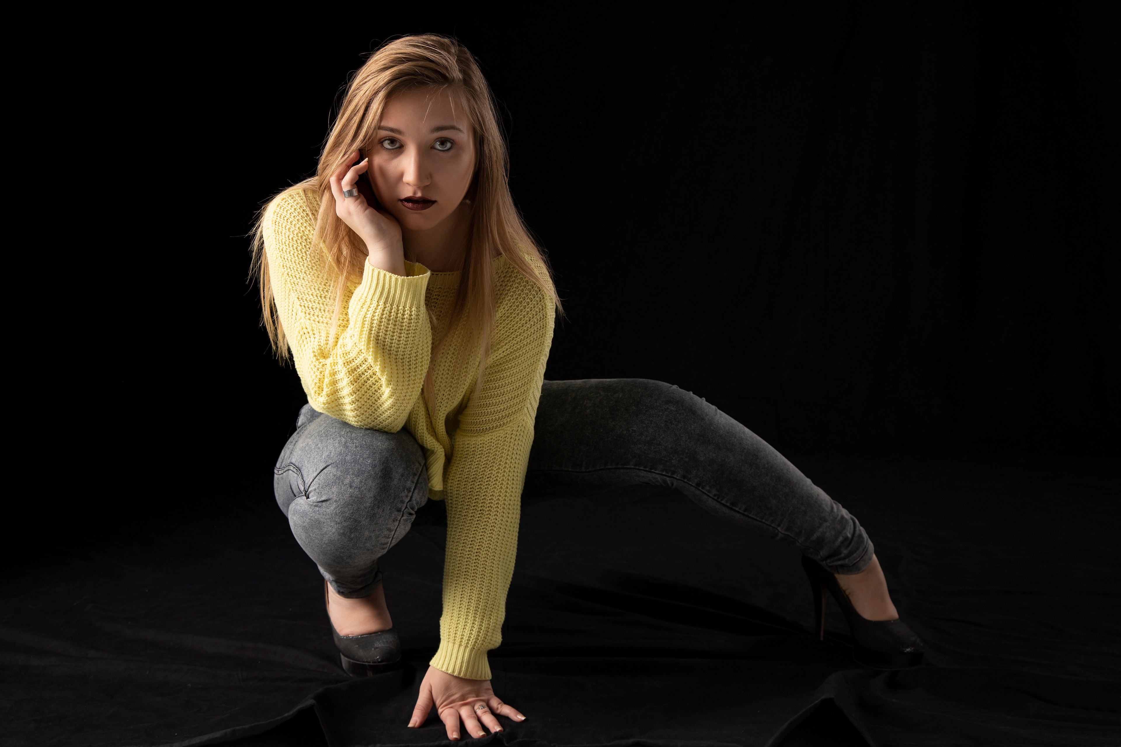 Blonde girl in yellow sweater and jeans posing HD Wallpaper