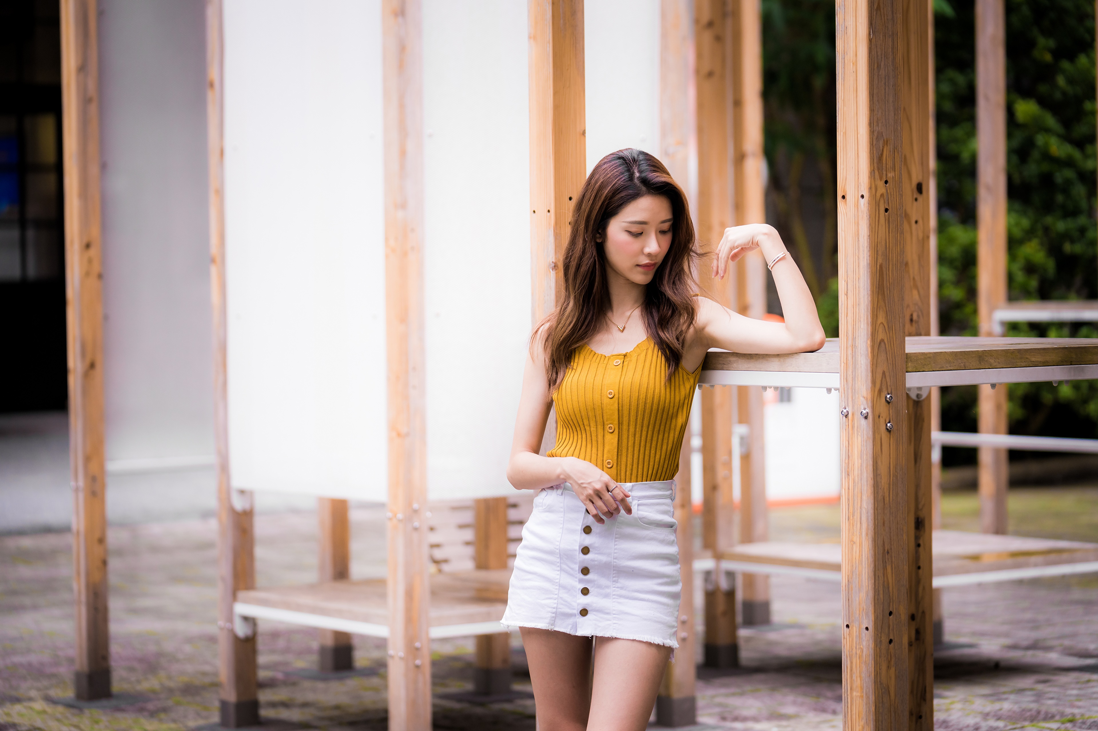 Asian woman in yellow top and white skirt posing HD Wallpaper