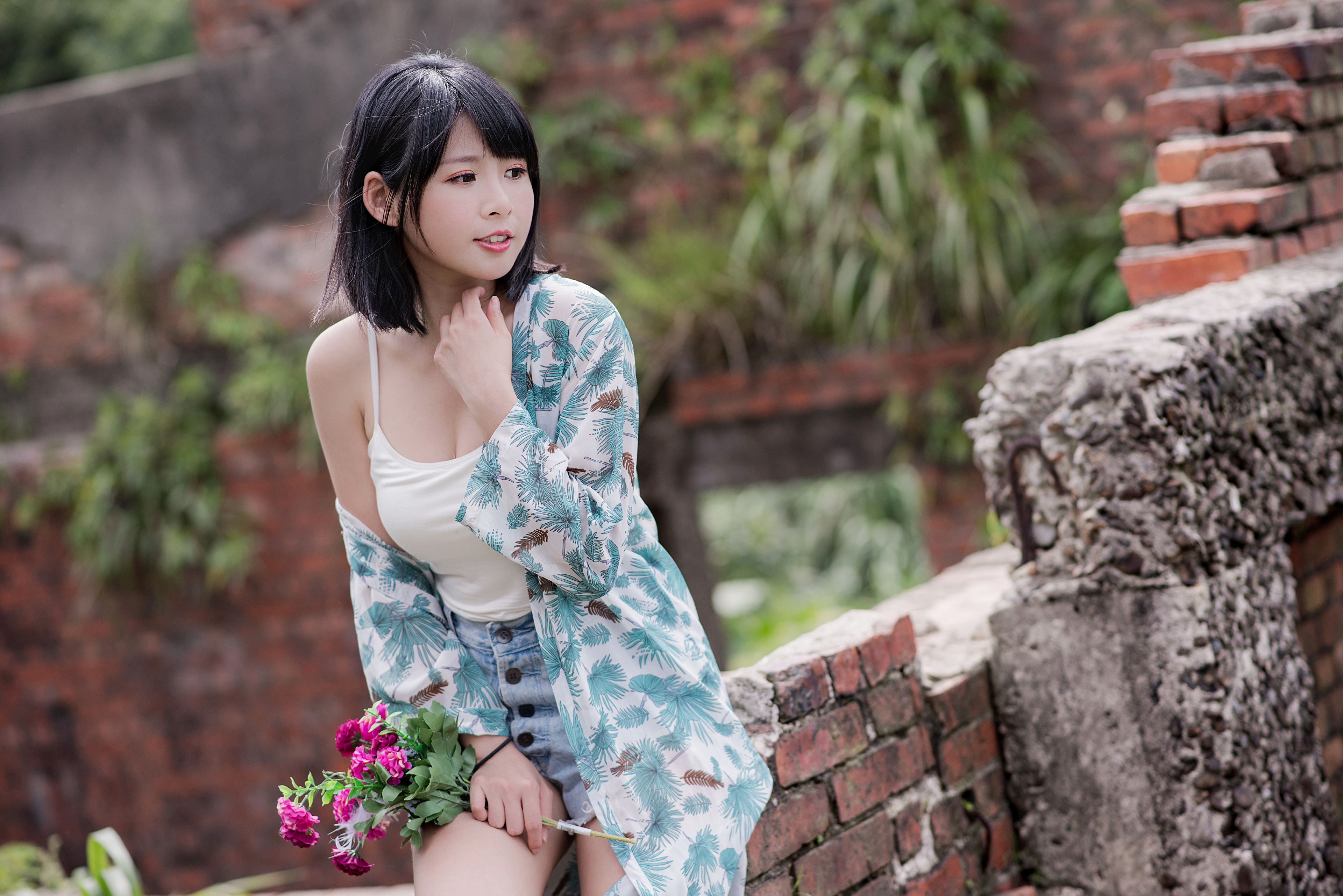 Asian girl with flowers near brick ruins HD Wallpaper
