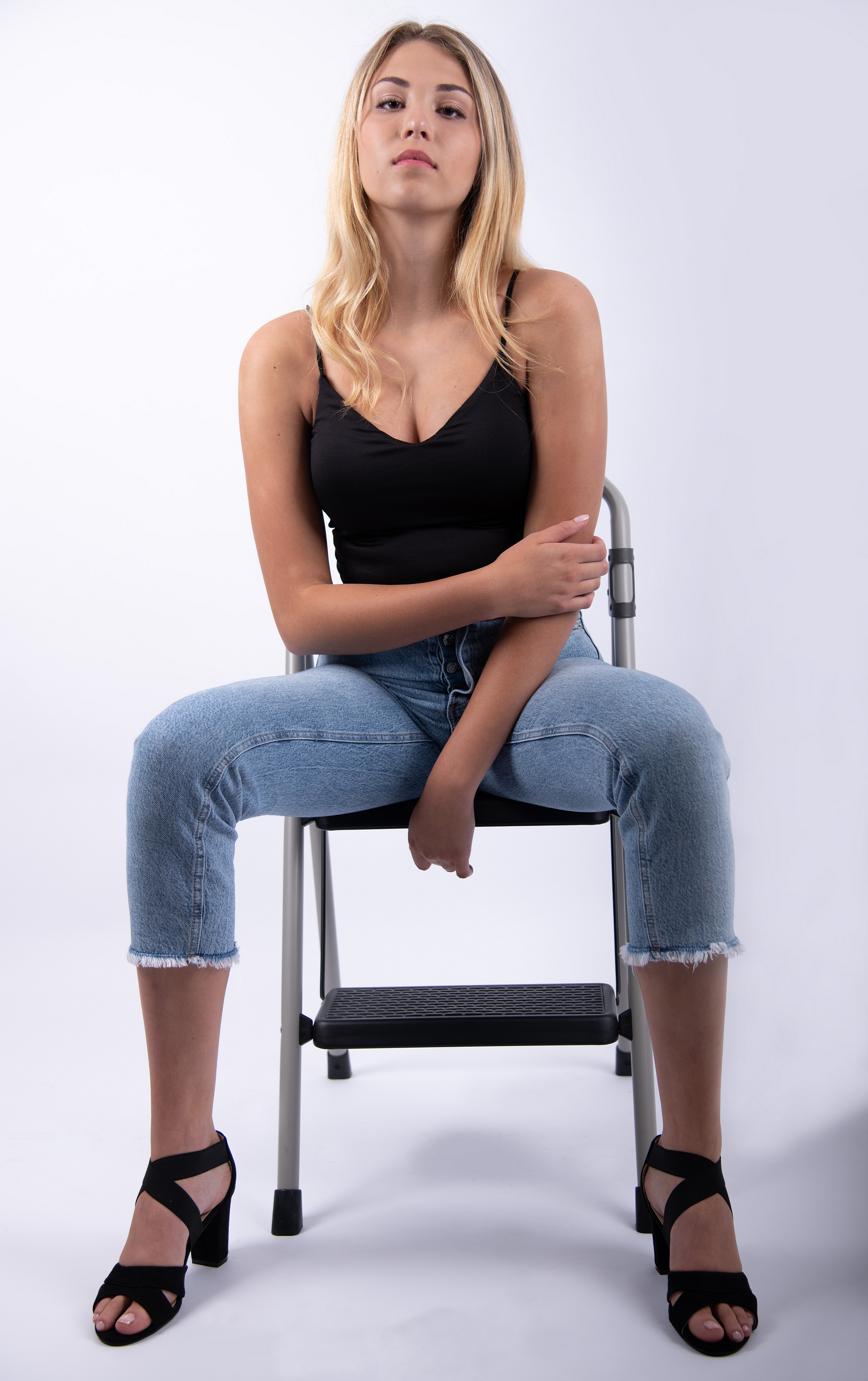 Mia Chagnon sitting on a step stool HD Phone Wallpaper