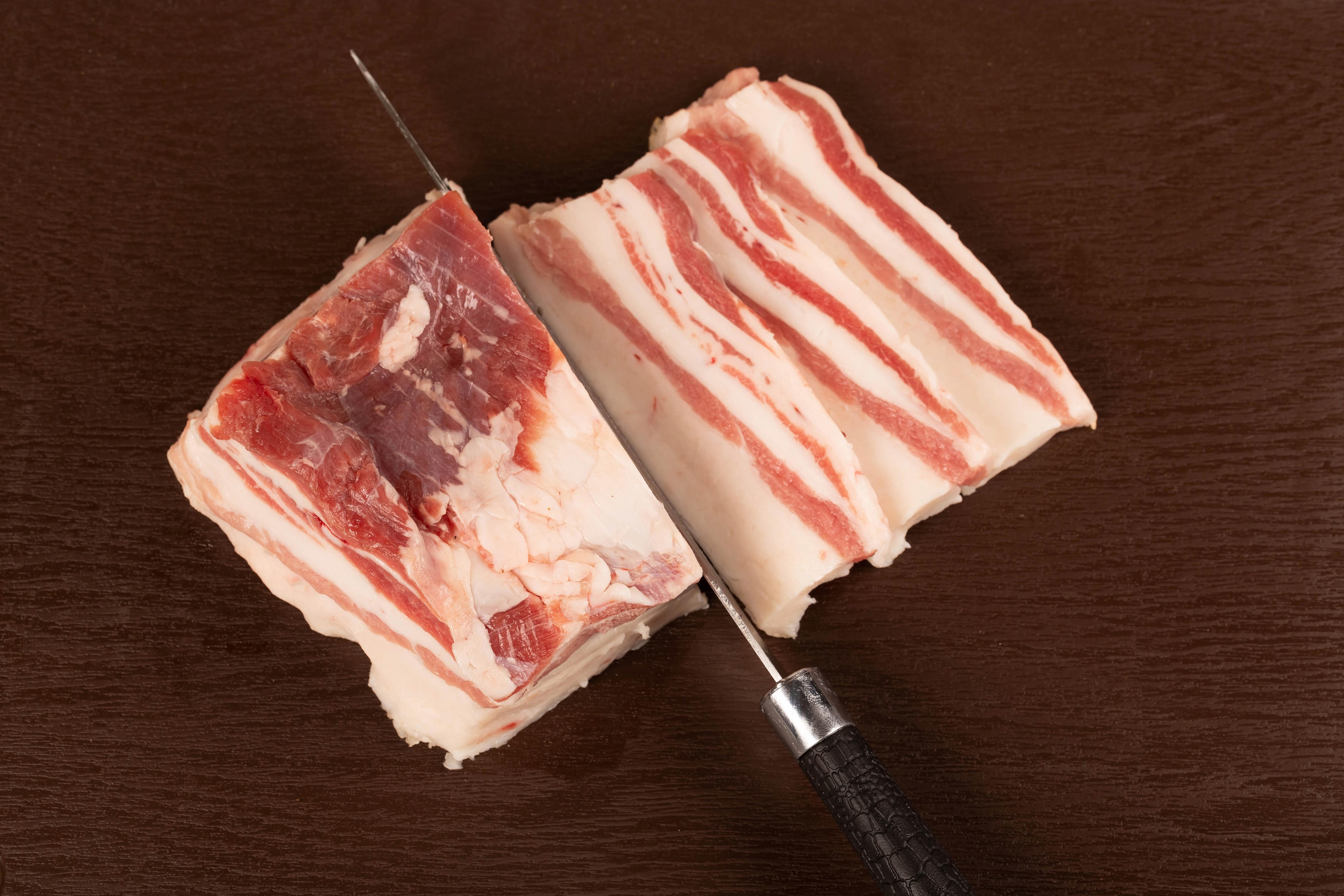 Knife slicing through a block of salo HD Wallpaper