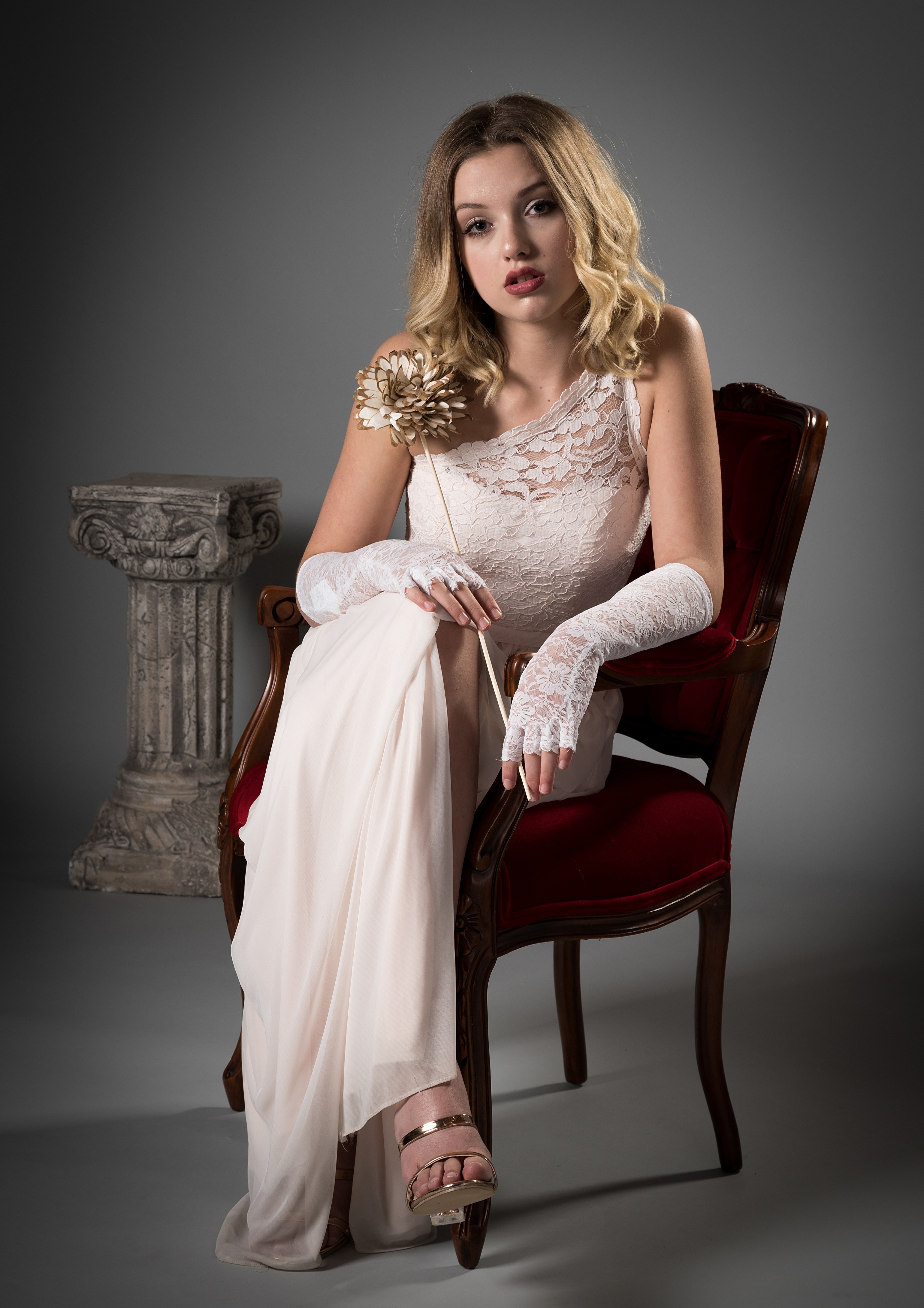 Blonde girl in a dress sitting in a chair HD Phone Wallpaper