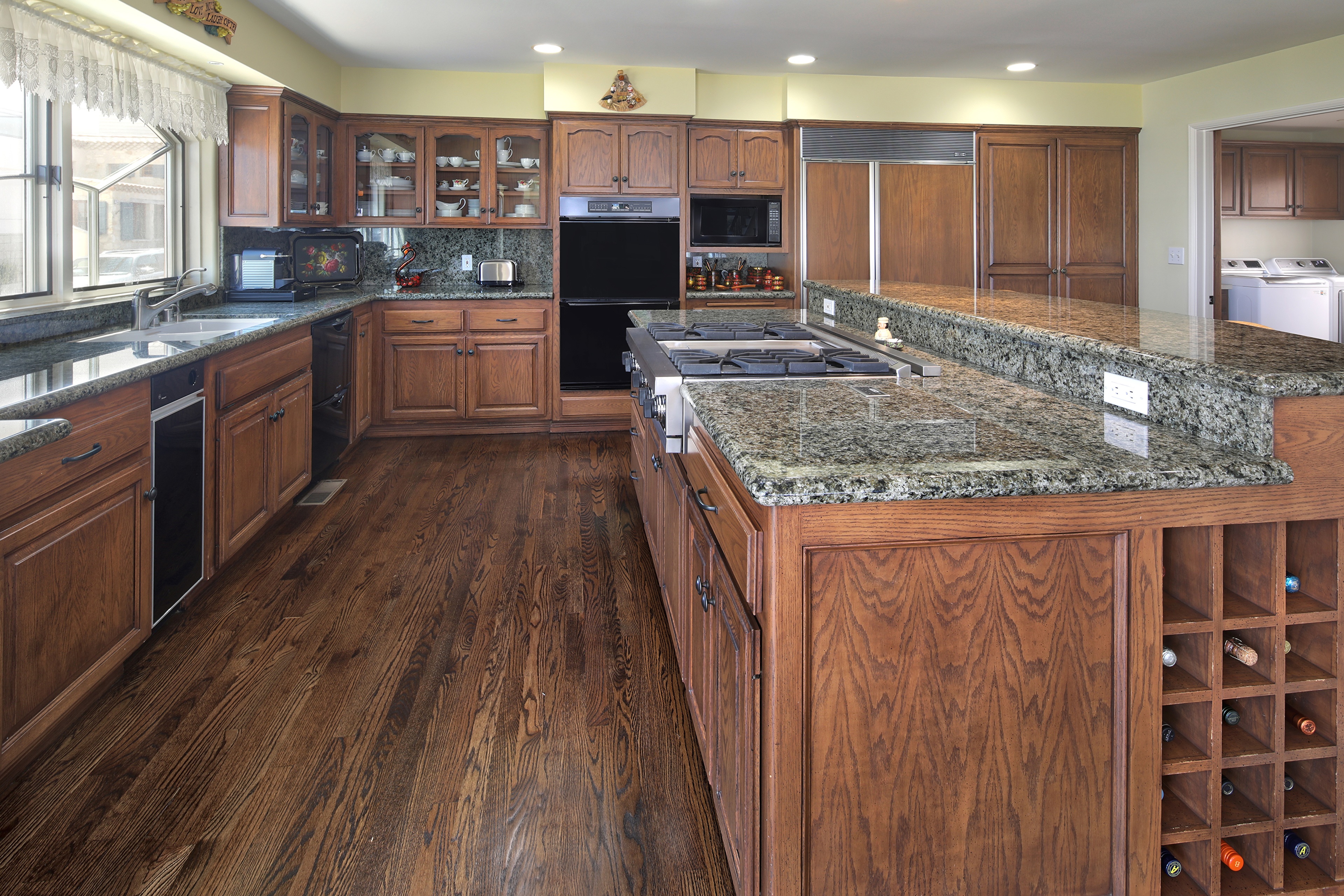 Kitchen interior with wooden cabinets and granite countertops HD Wallpaper