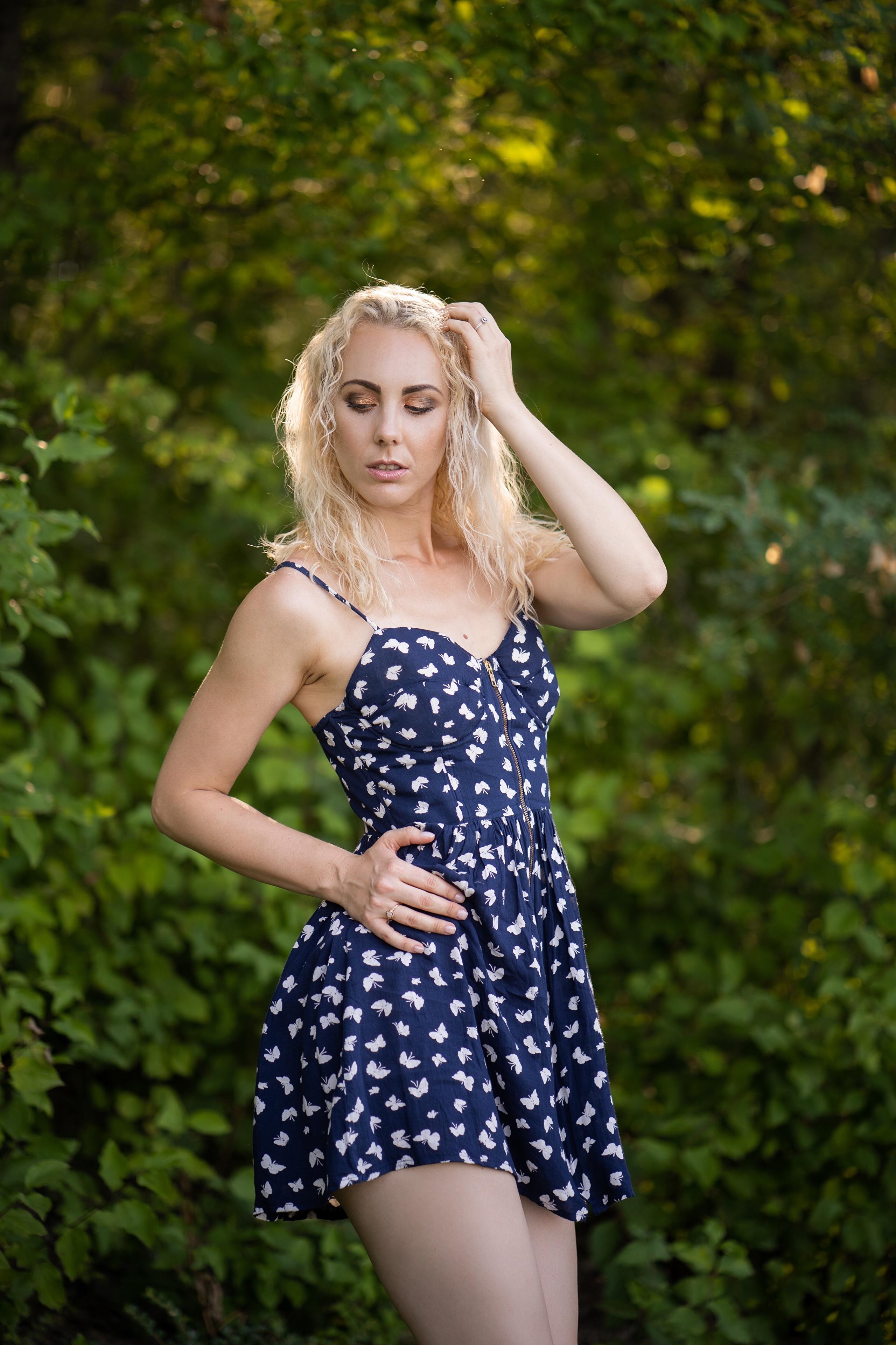 Blonde woman in a blue butterfly dress posing outdoors HD Phone Wallpaper