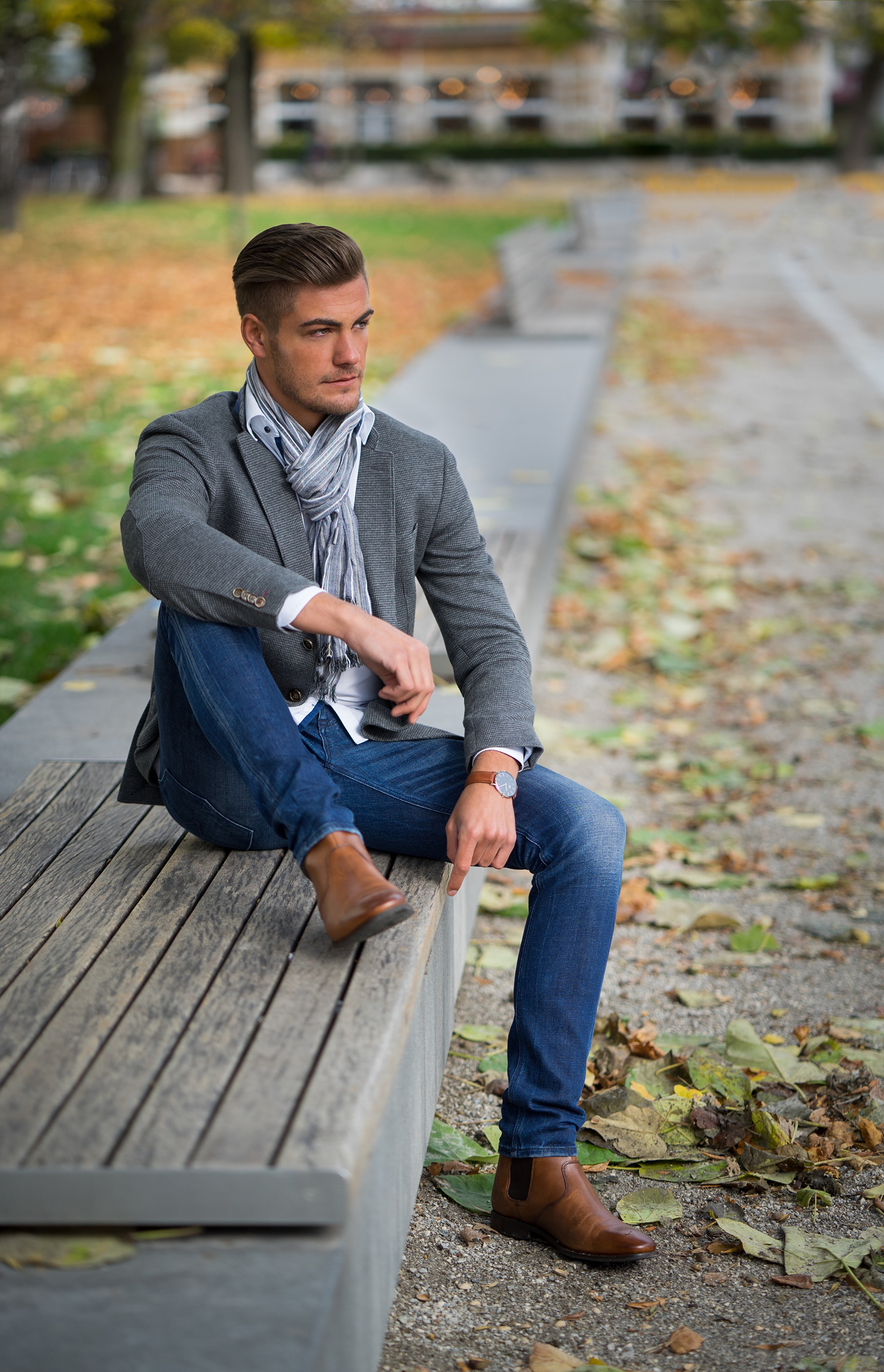 Man in suit and scarf sitting on a park bench HD Phone Wallpaper