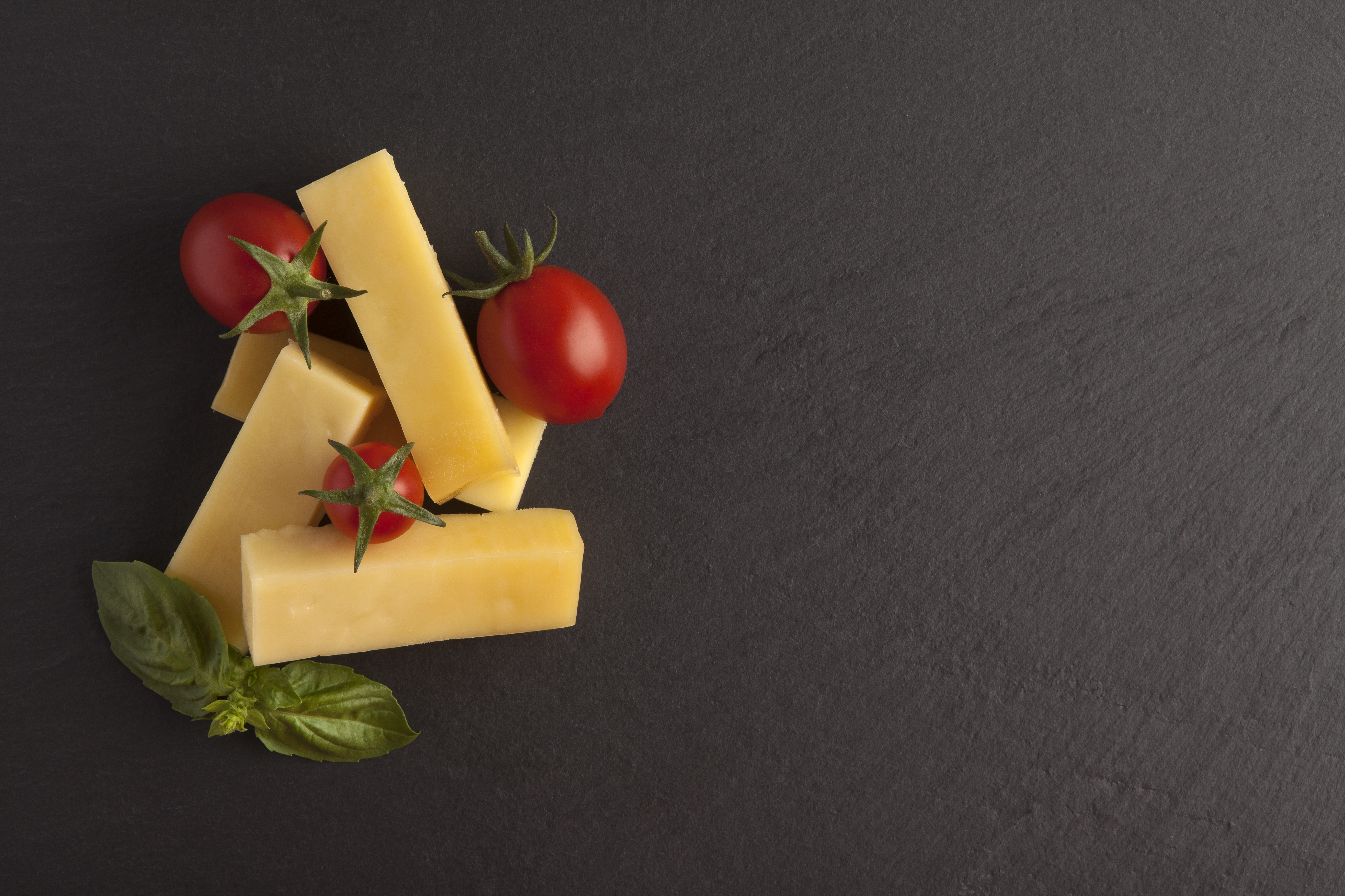 Cheese sticks with tomatoes and basil on a gray background HD Wallpaper