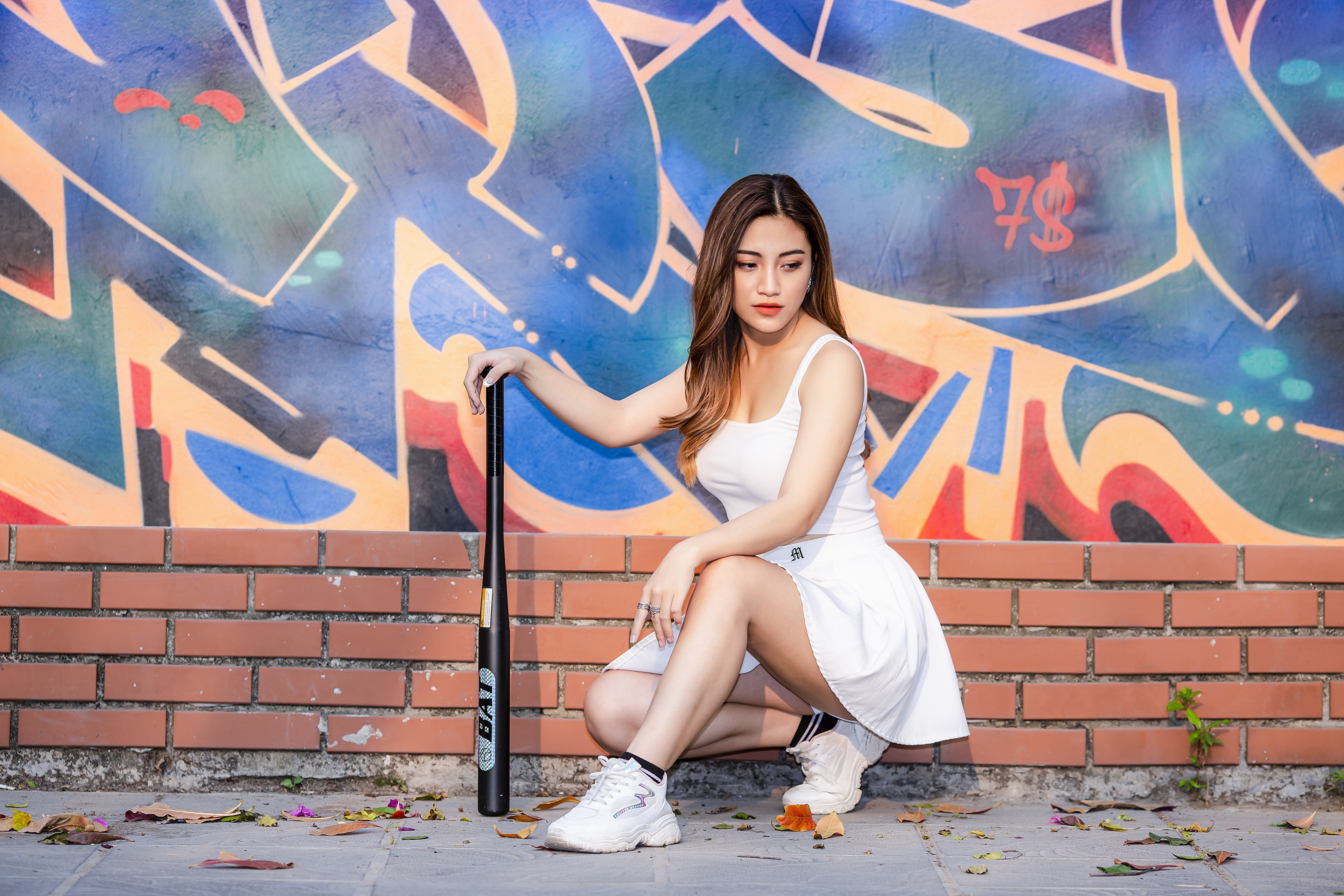 Woman with Baseball Bat Posing in Front of Graffiti Wall HD Wallpaper