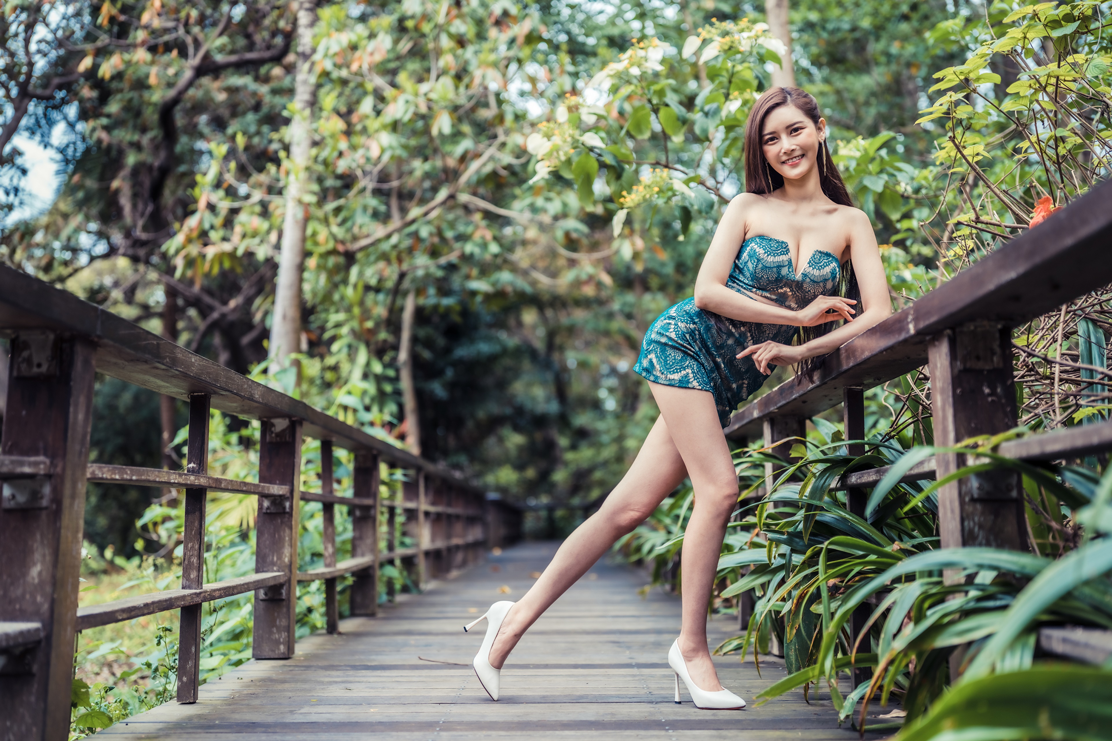 Asian woman in a dress posing on a wooden bridge HD Wallpaper