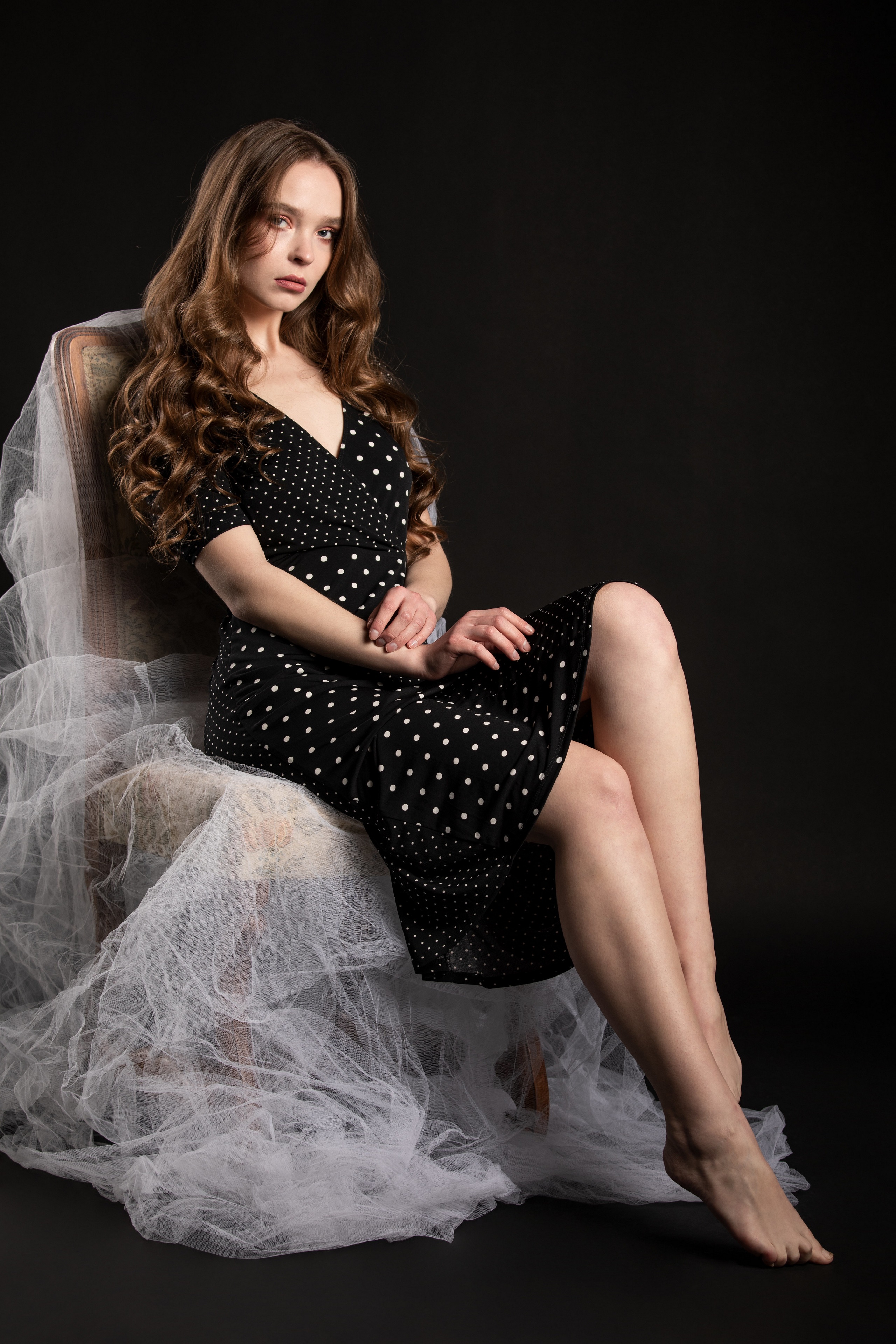 Silvy Sirius sitting on a chair in a polka dot dress HD Phone Wallpaper