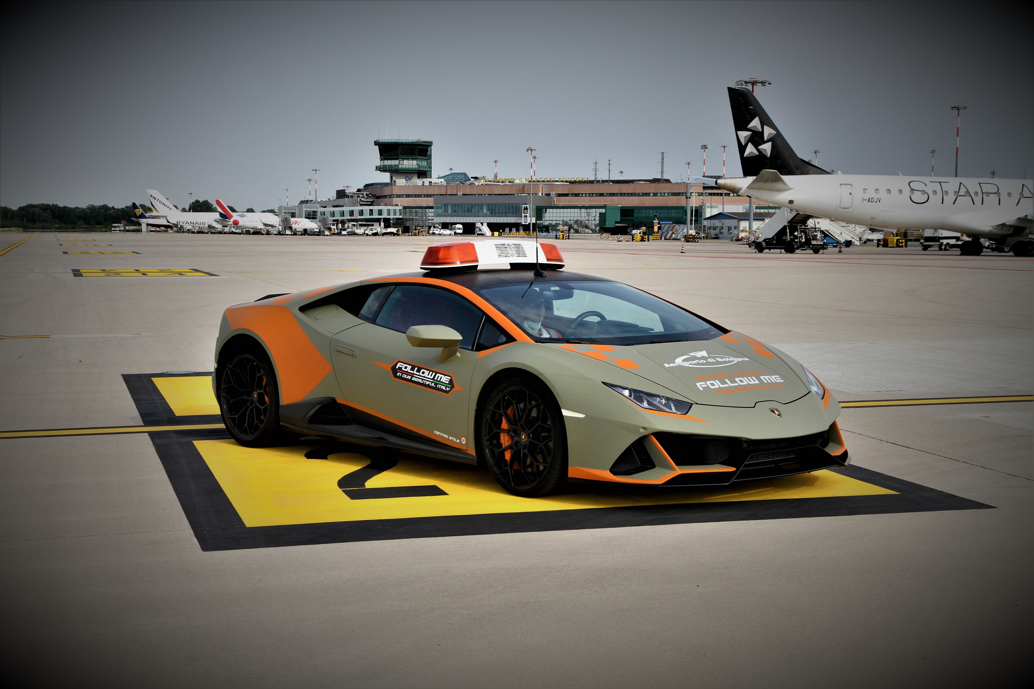 Follow Me Lamborghini at Airport HD Wallpaper