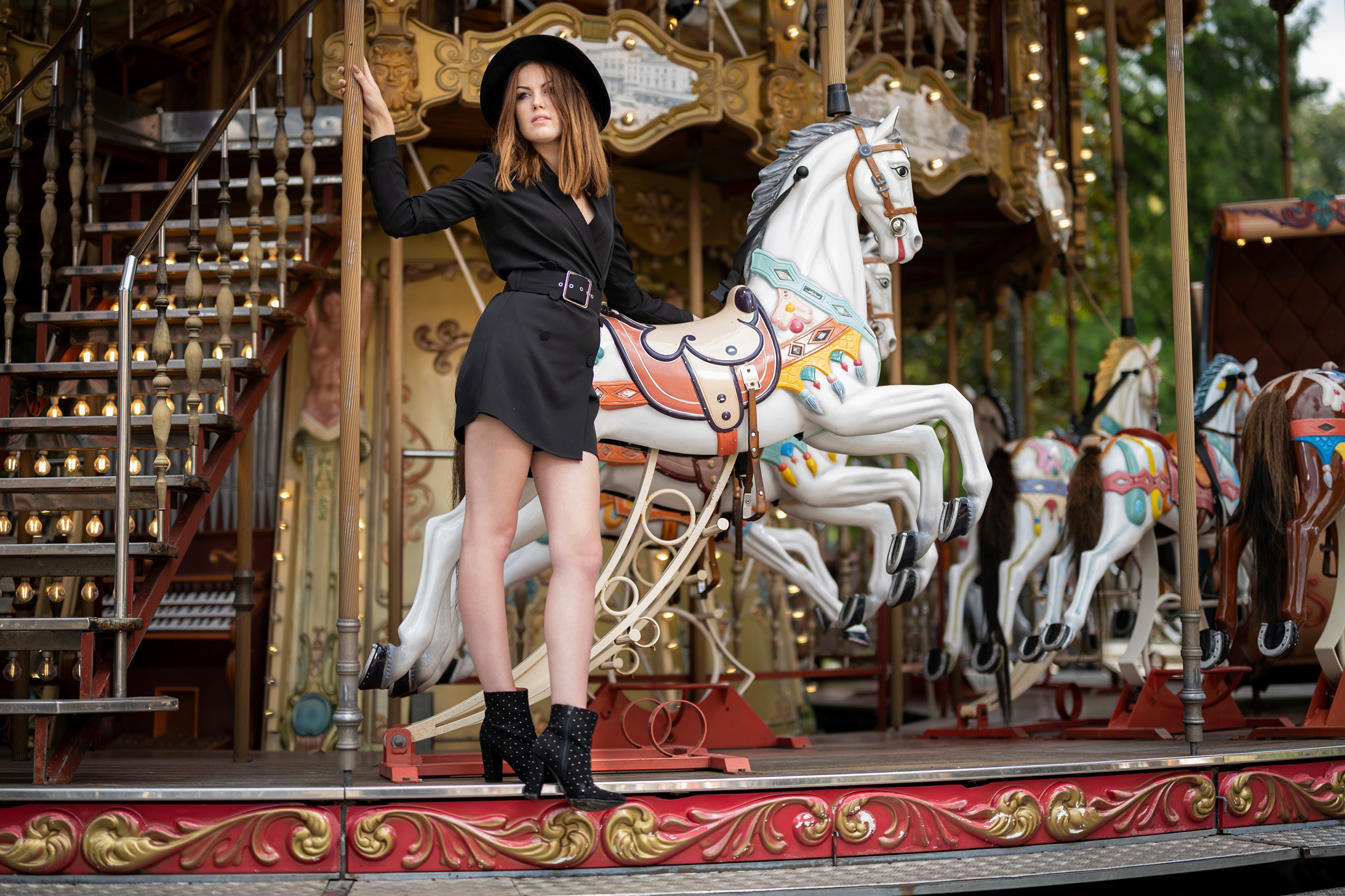 Woman in black dress and hat on carousel HD Wallpaper