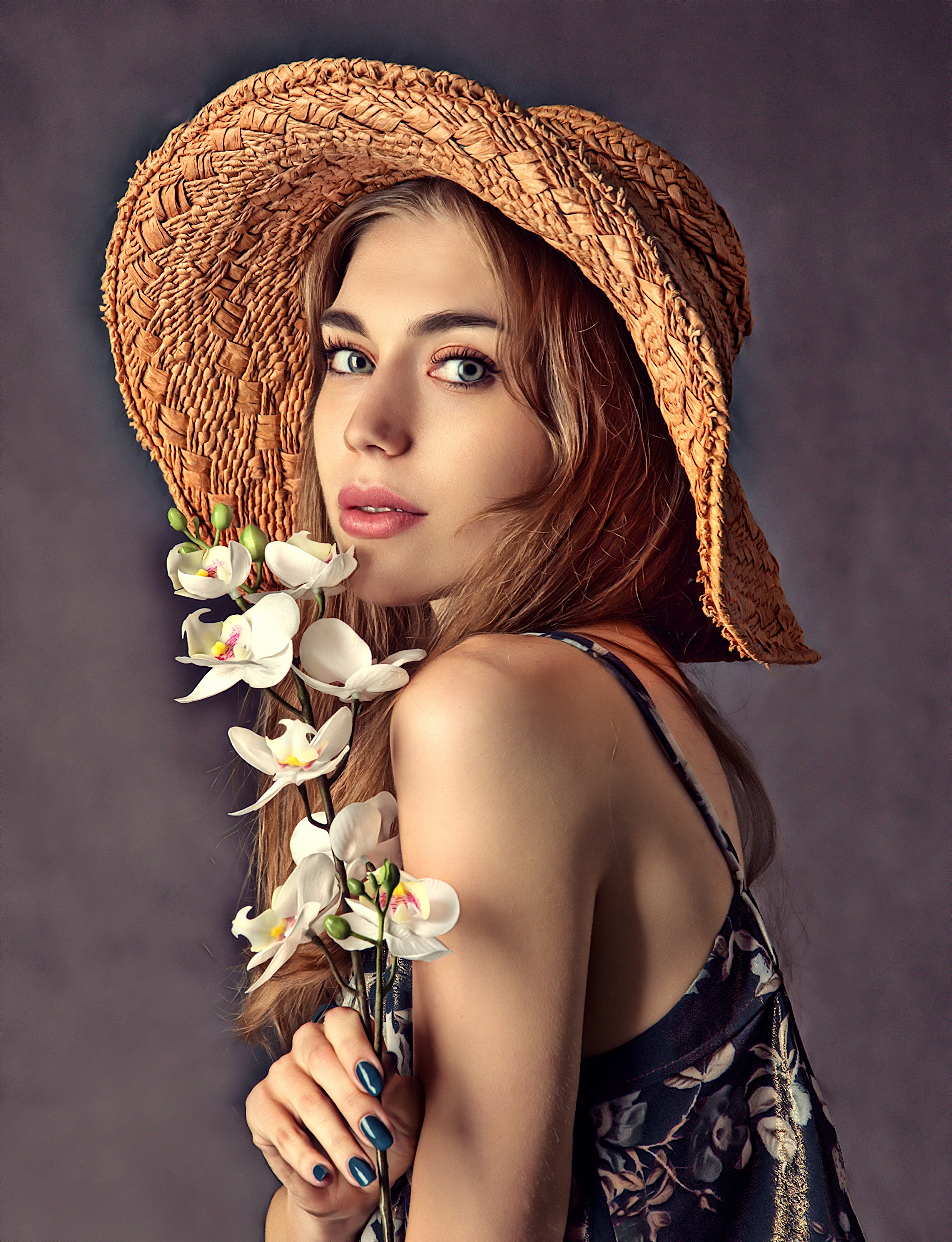 Woman in a straw hat holding white orchids HD Phone Wallpaper