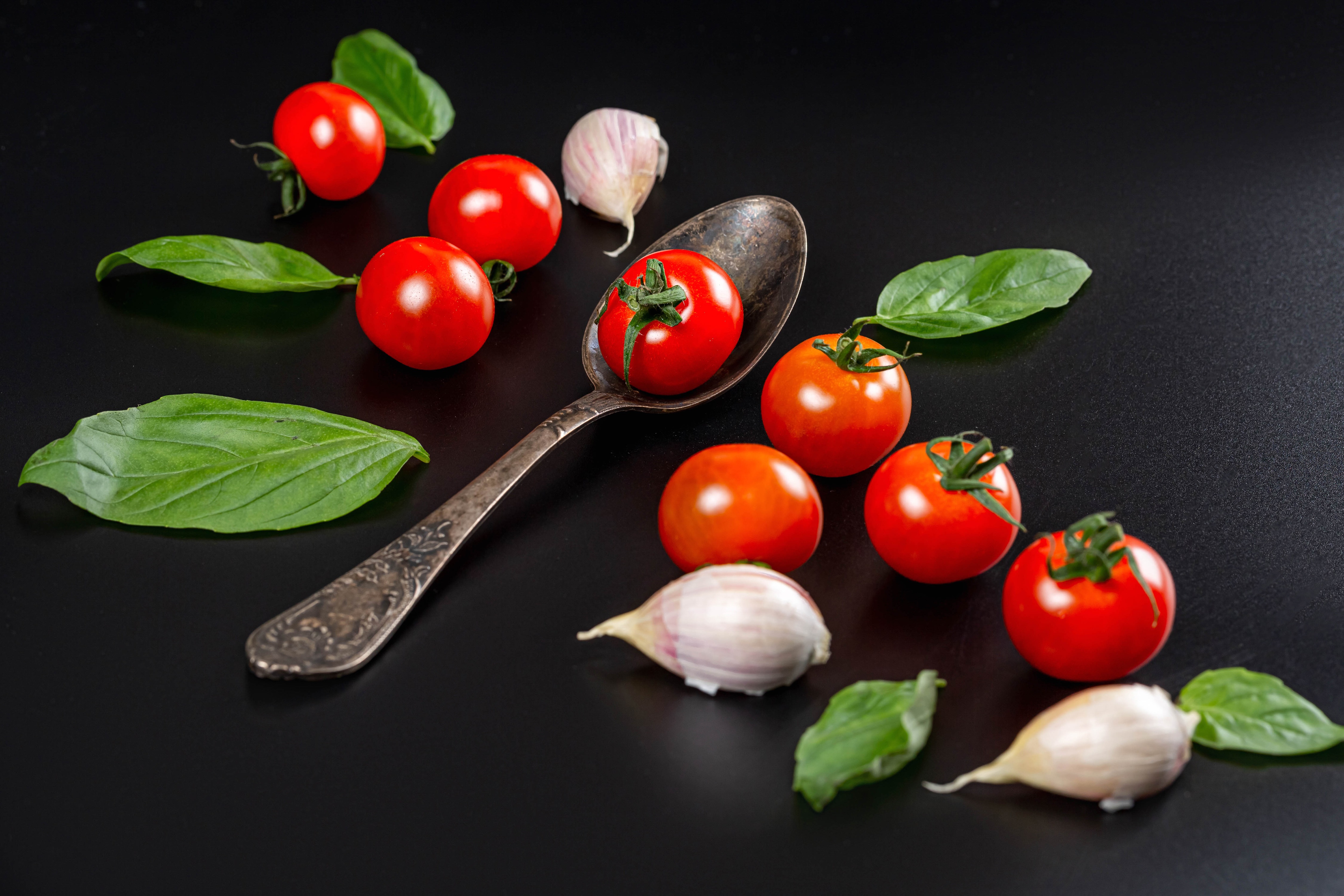 Tomatoes, Garlic, Basil, and Spoon on Black HD Wallpaper