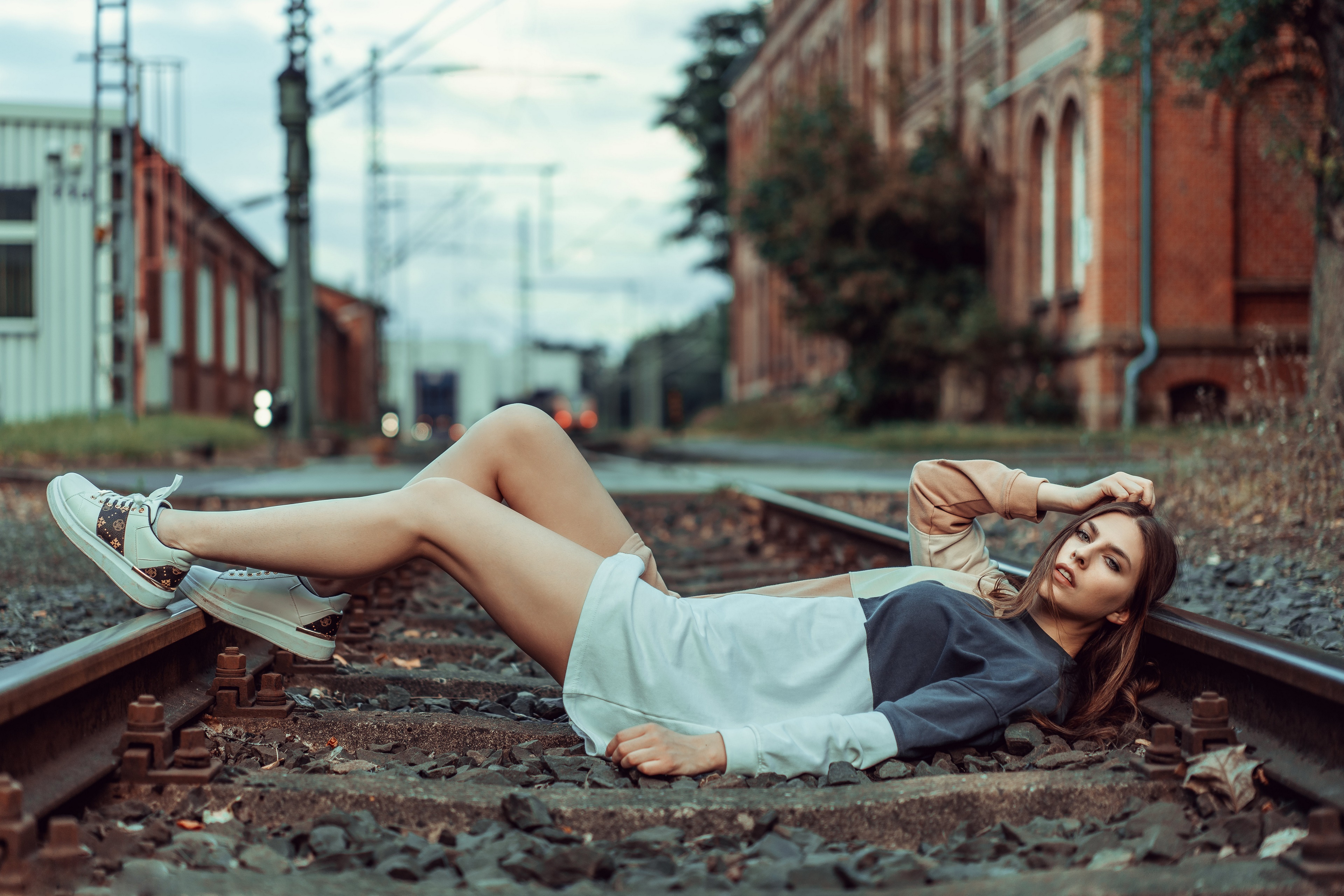 Beatrice Rogall lying on train tracks HD Wallpaper