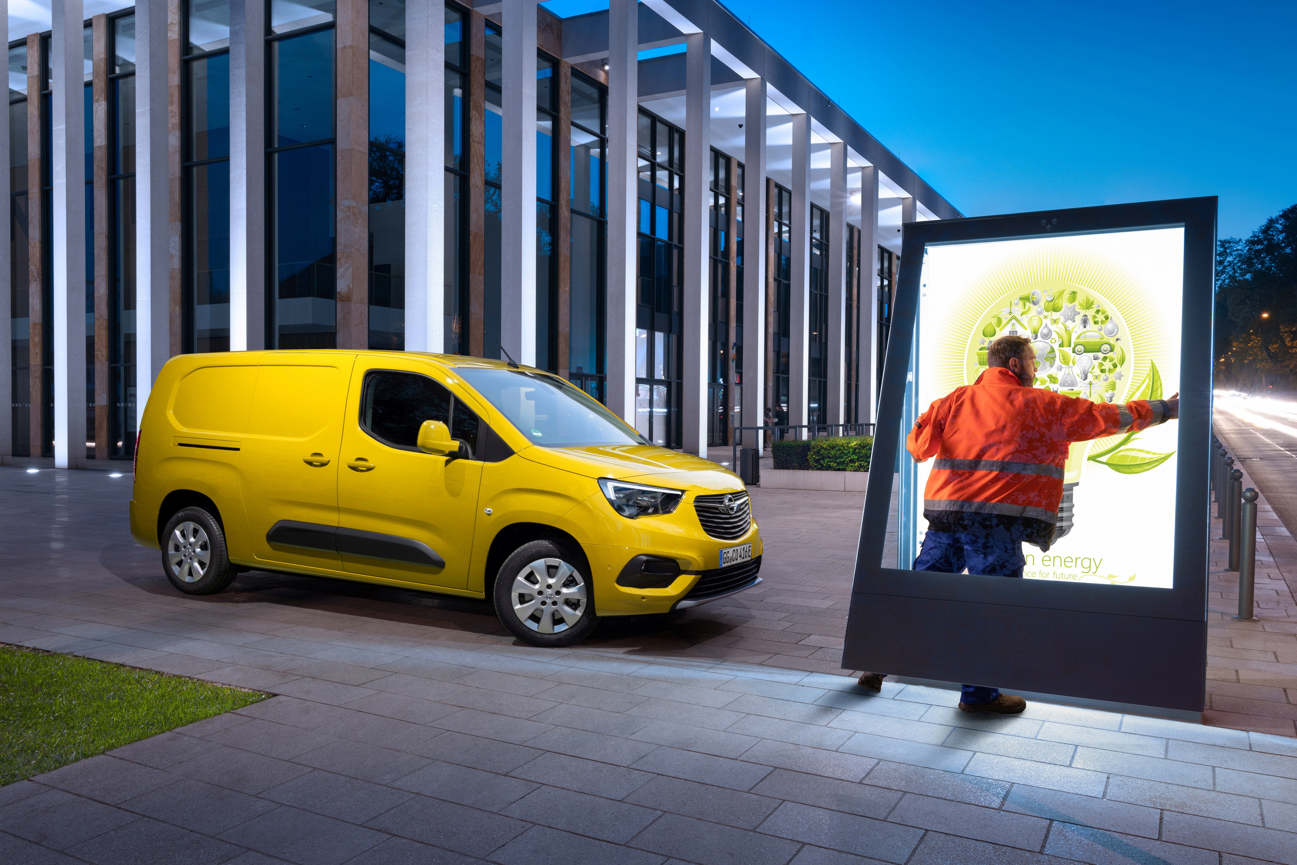 Opel Combo-e Cargo XL van and worker with billboard HD Wallpaper