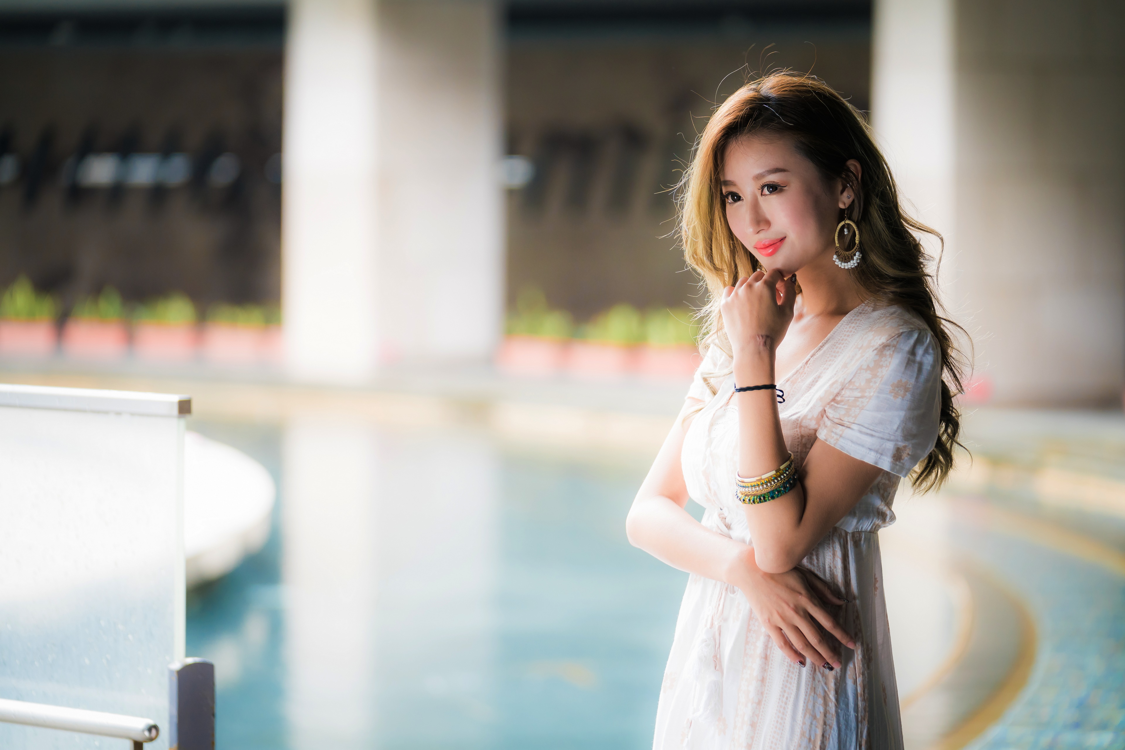 Asian woman with jewelry posing by a pool HD Wallpaper