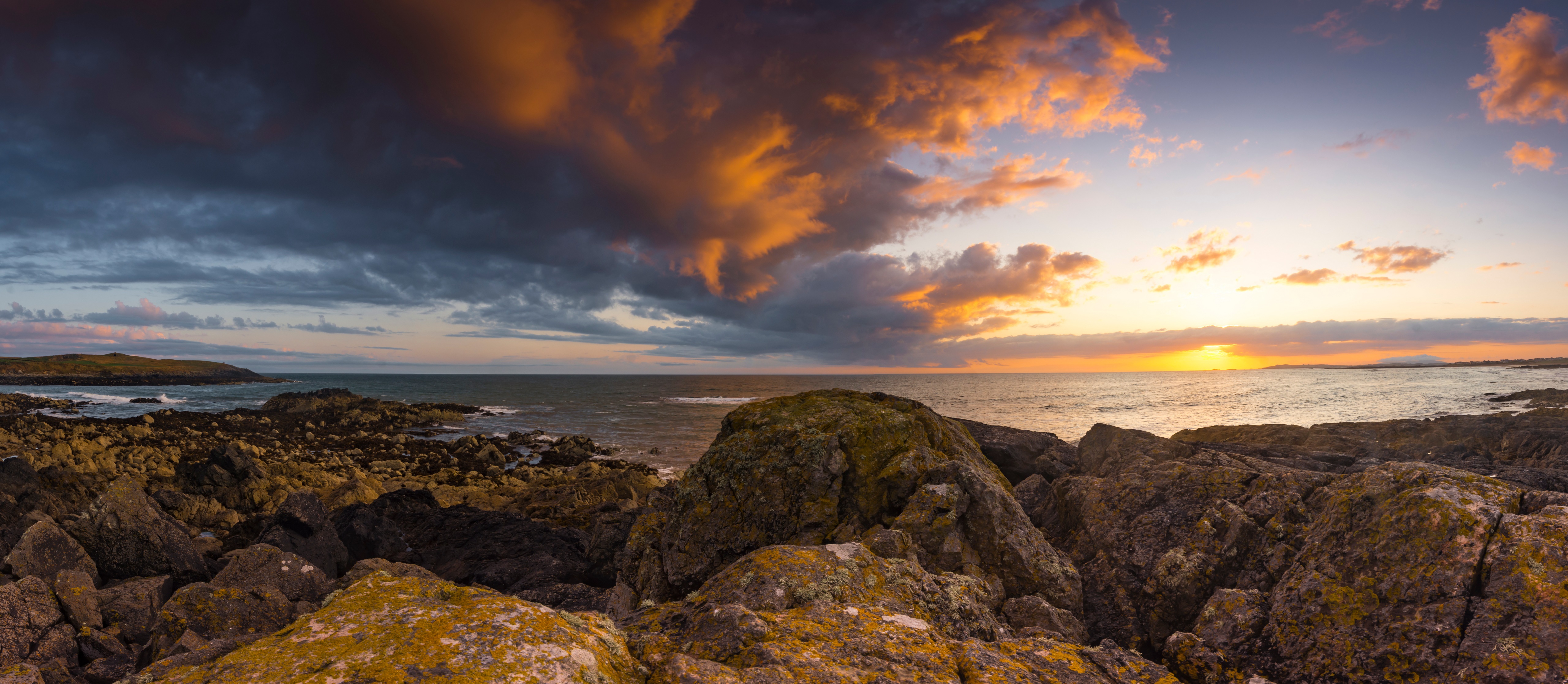 Sunset over rocky coast at Porth Nobla, Wales HD Wallpaper