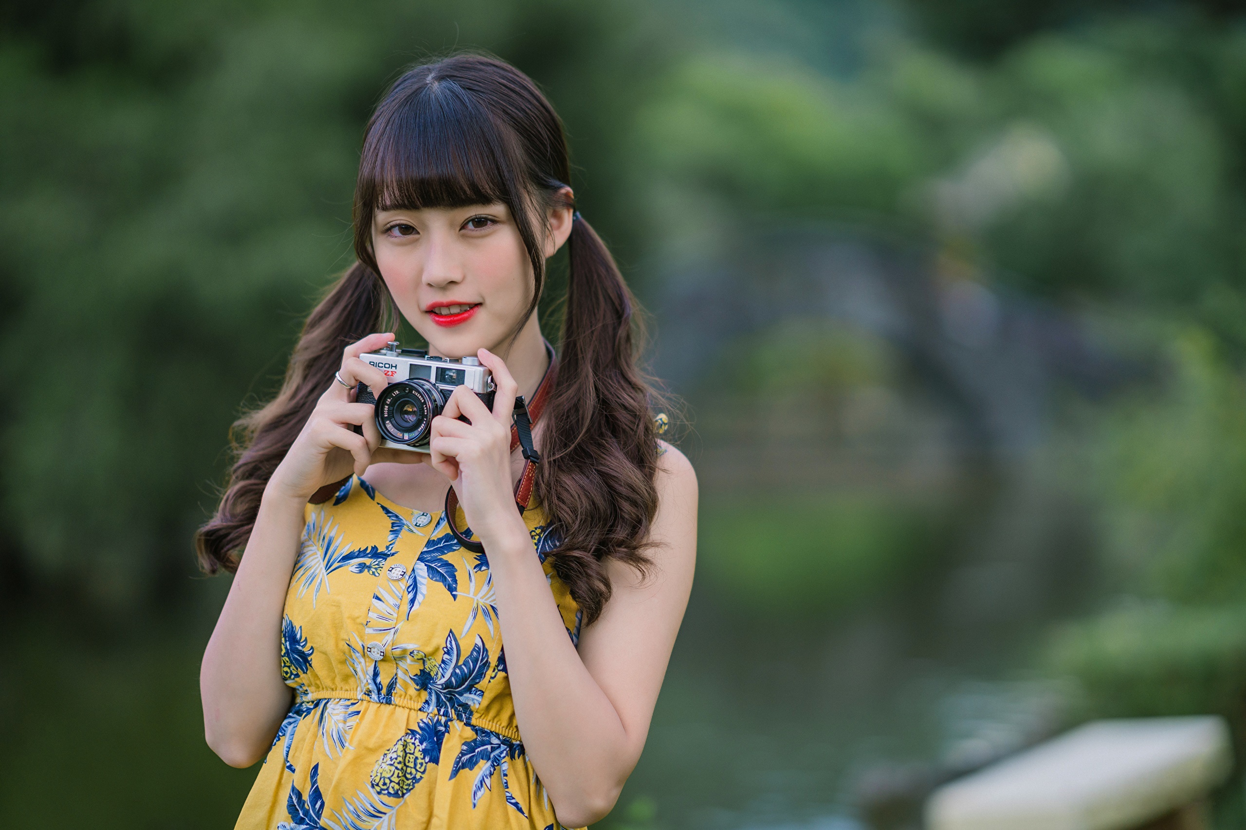 Asian woman holding a Ricoh camera HD Wallpaper