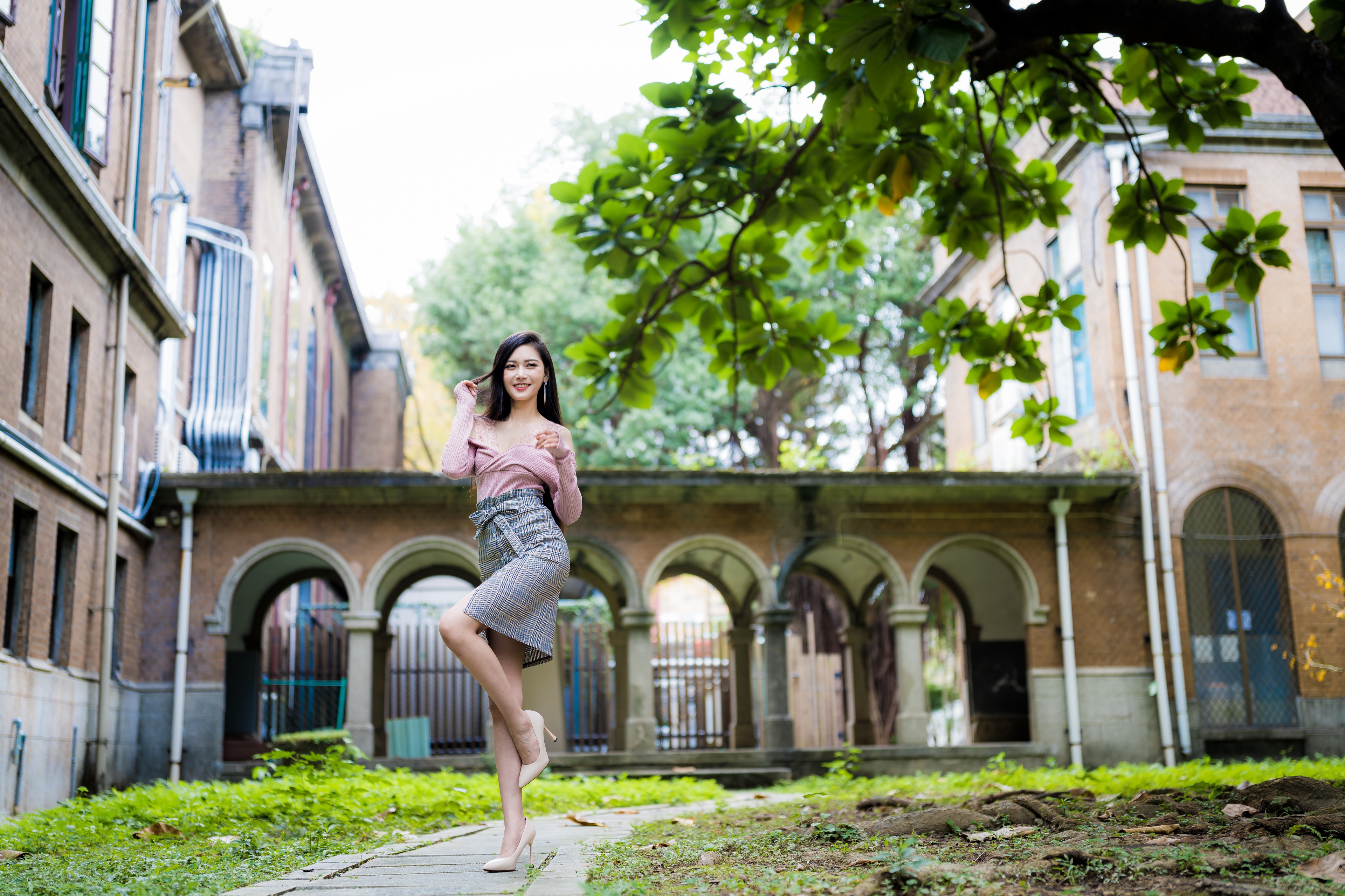 Asian woman posing in front of a building HD Wallpaper