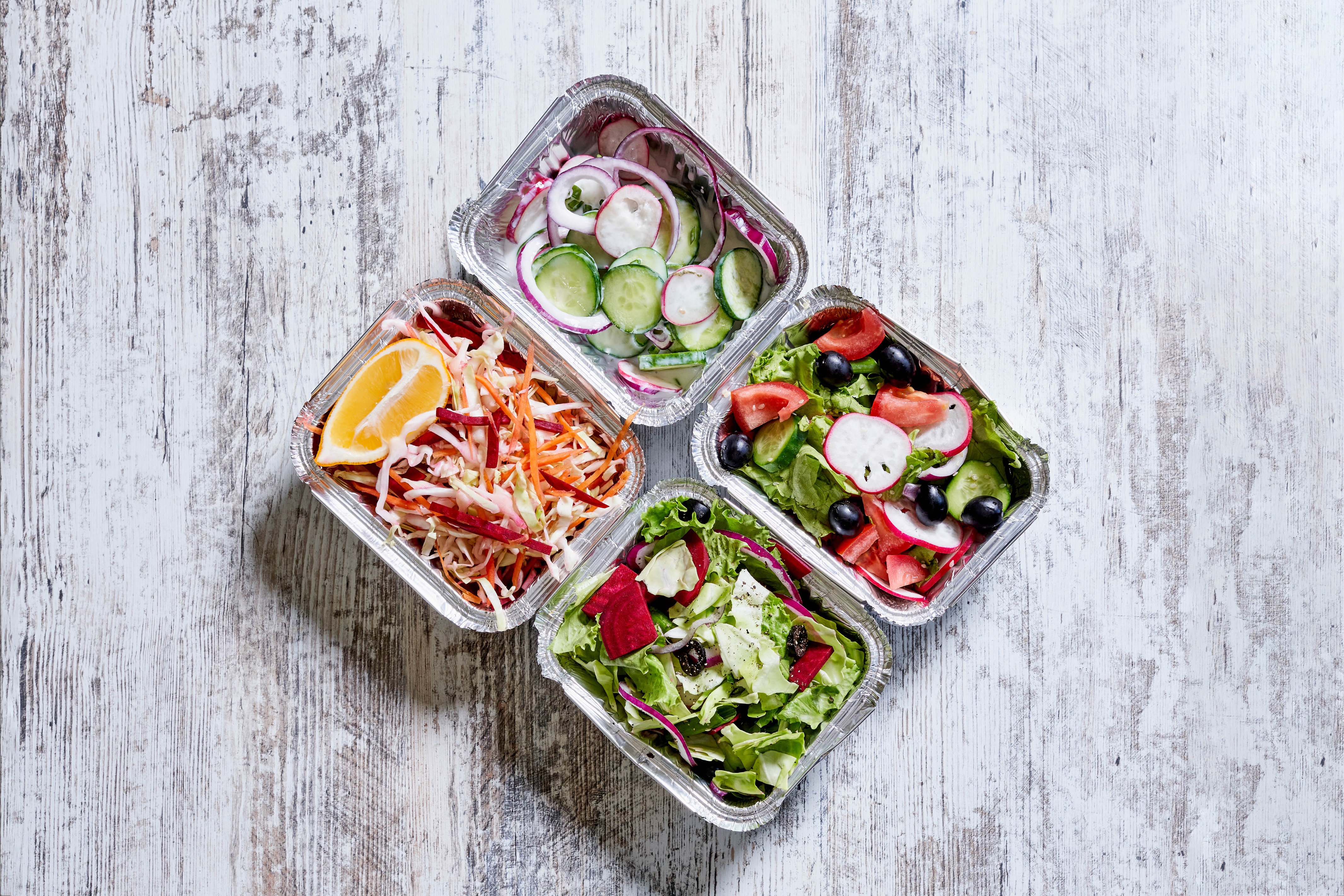 Four foil containers of salads with vegetables HD Wallpaper