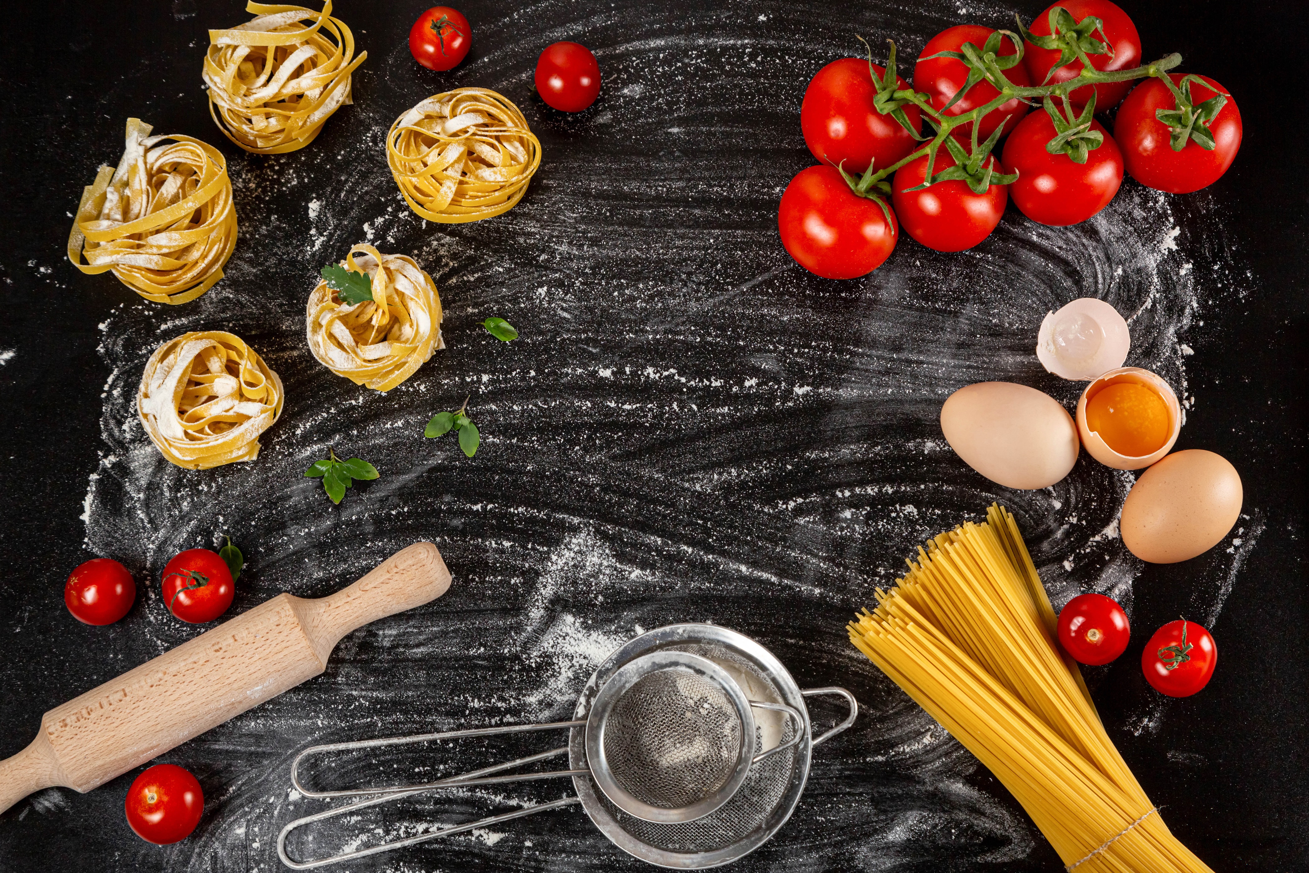 Pasta ingredients with tomatoes and eggs on flour HD Wallpaper