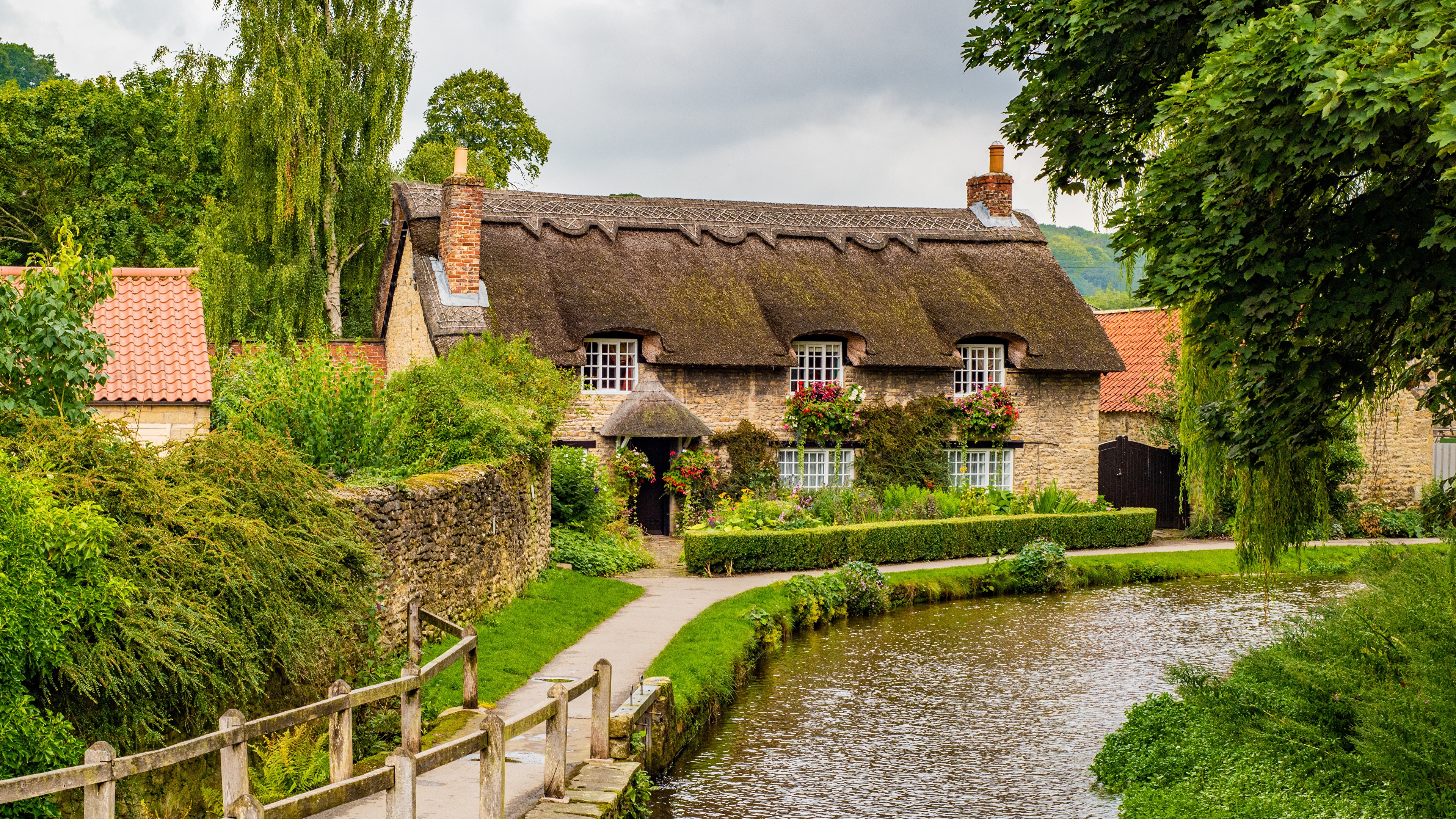 Thatched Cottage by a Stream in Thornton Dale, England HD Wallpaper